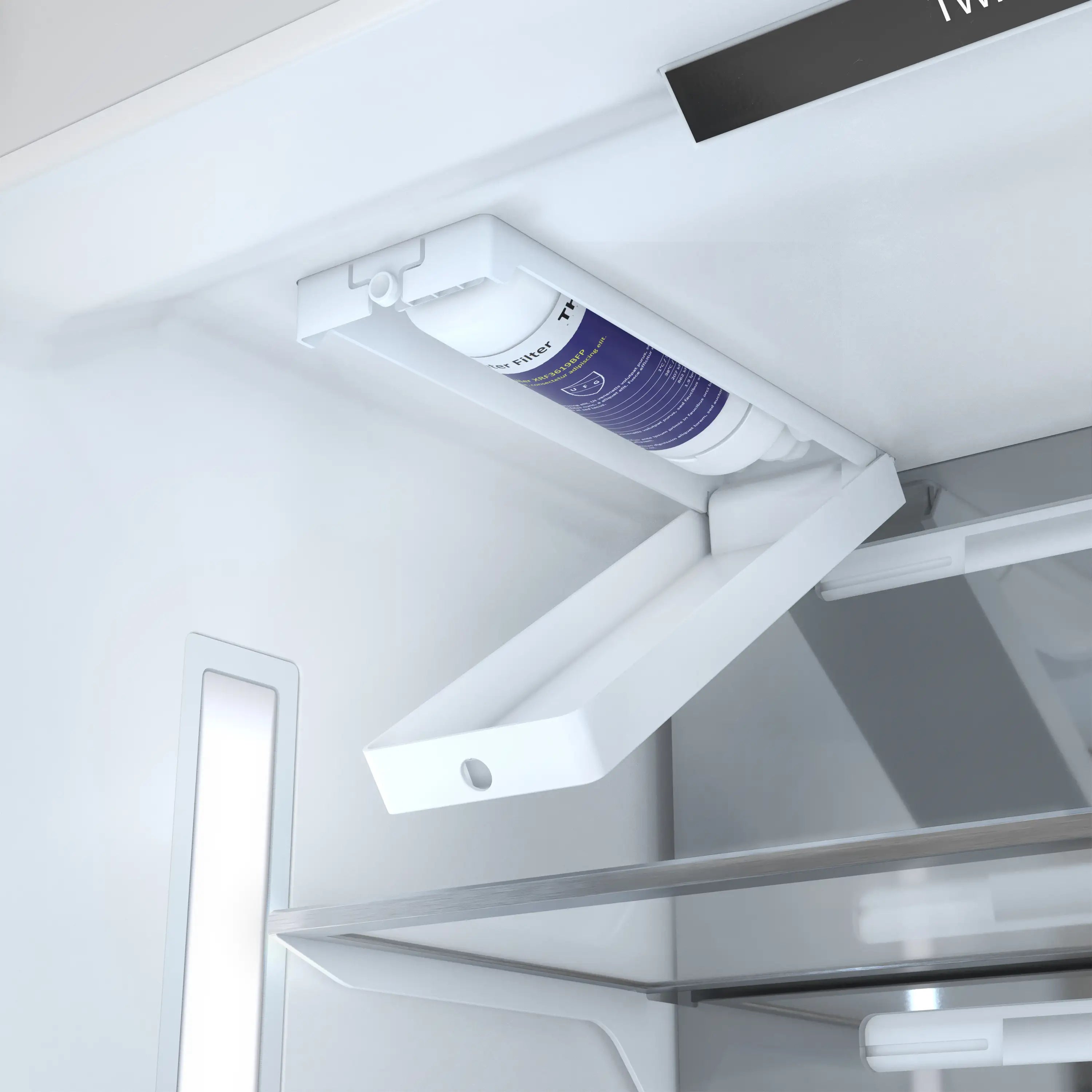 Ice maker chute area with visible water filter cartridge inside freezer