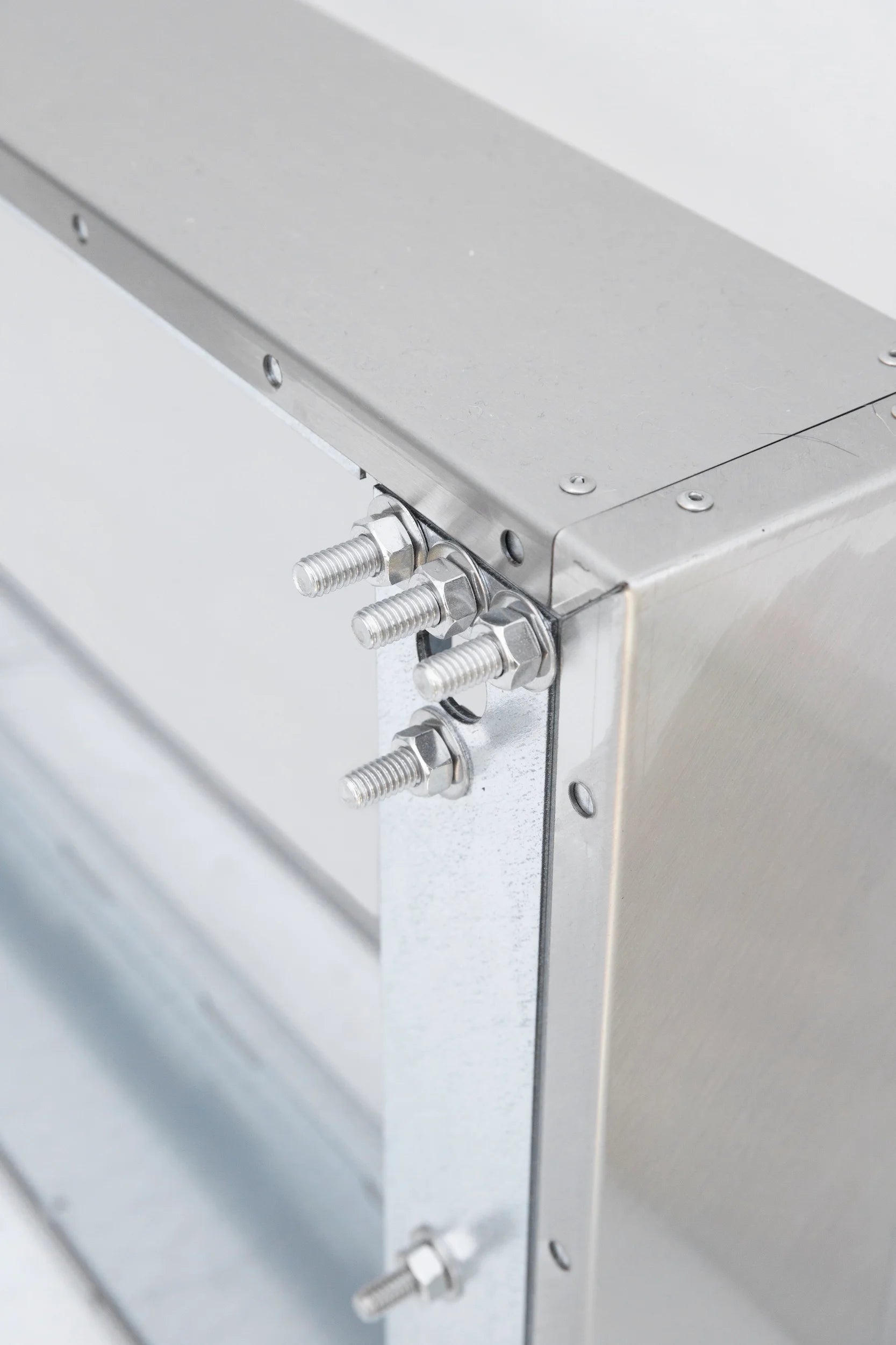 Metal vent hood spacer bracket with threaded bolts and mounting plate