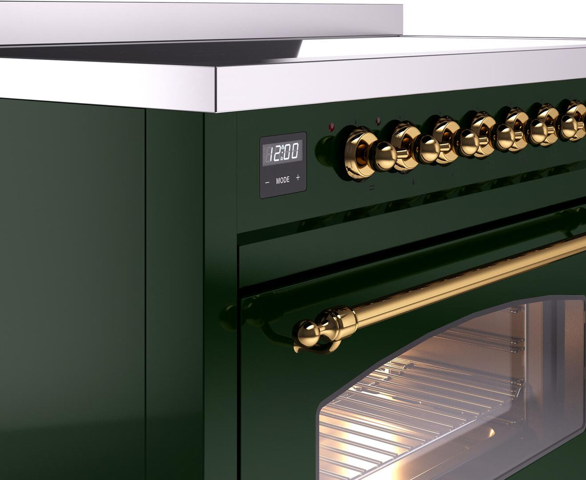 Emerald green freestanding electric induction range control panel with brass knobs