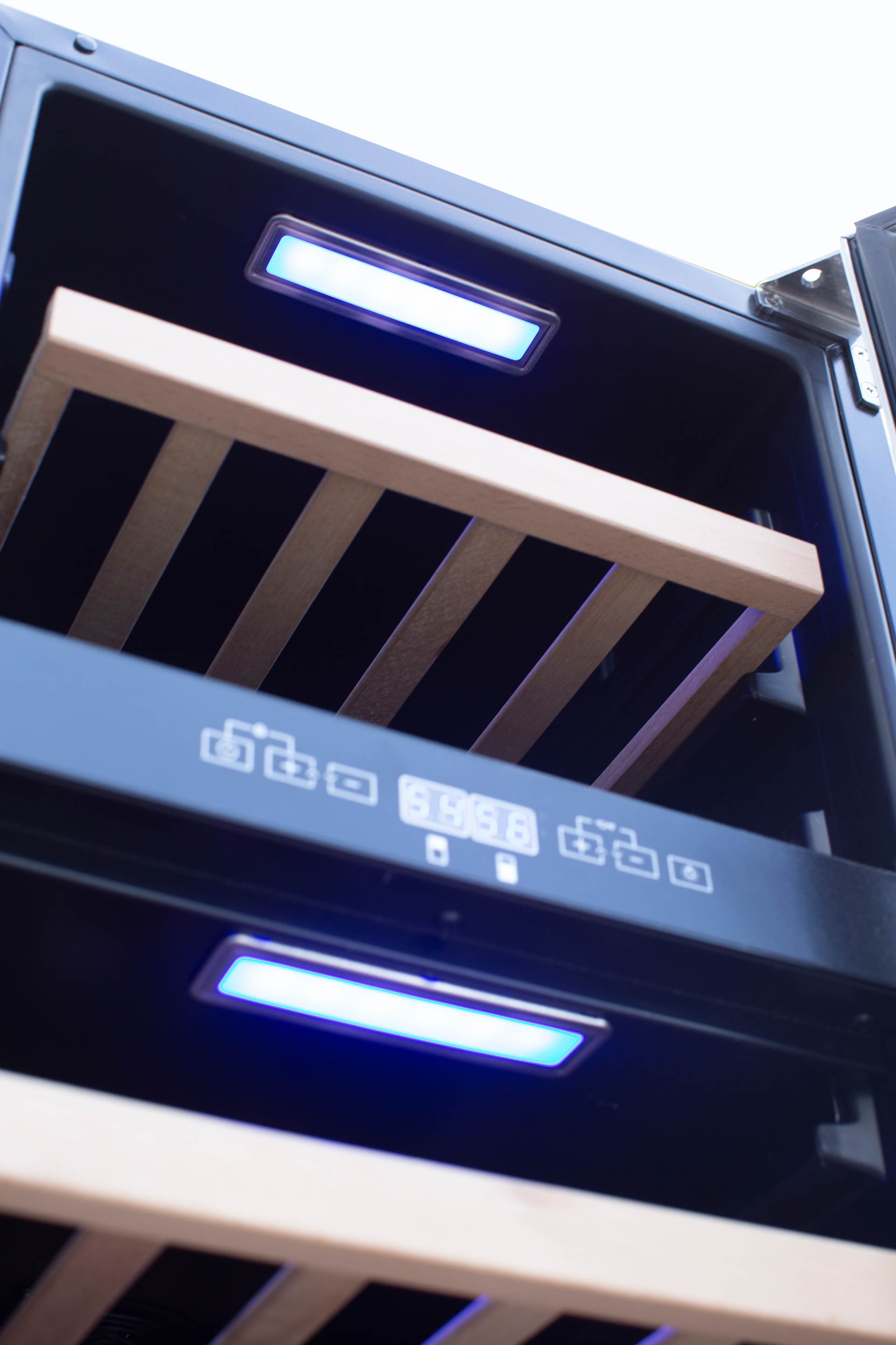 Wine cooler door open interior showing wooden rack slats and blue LED strip