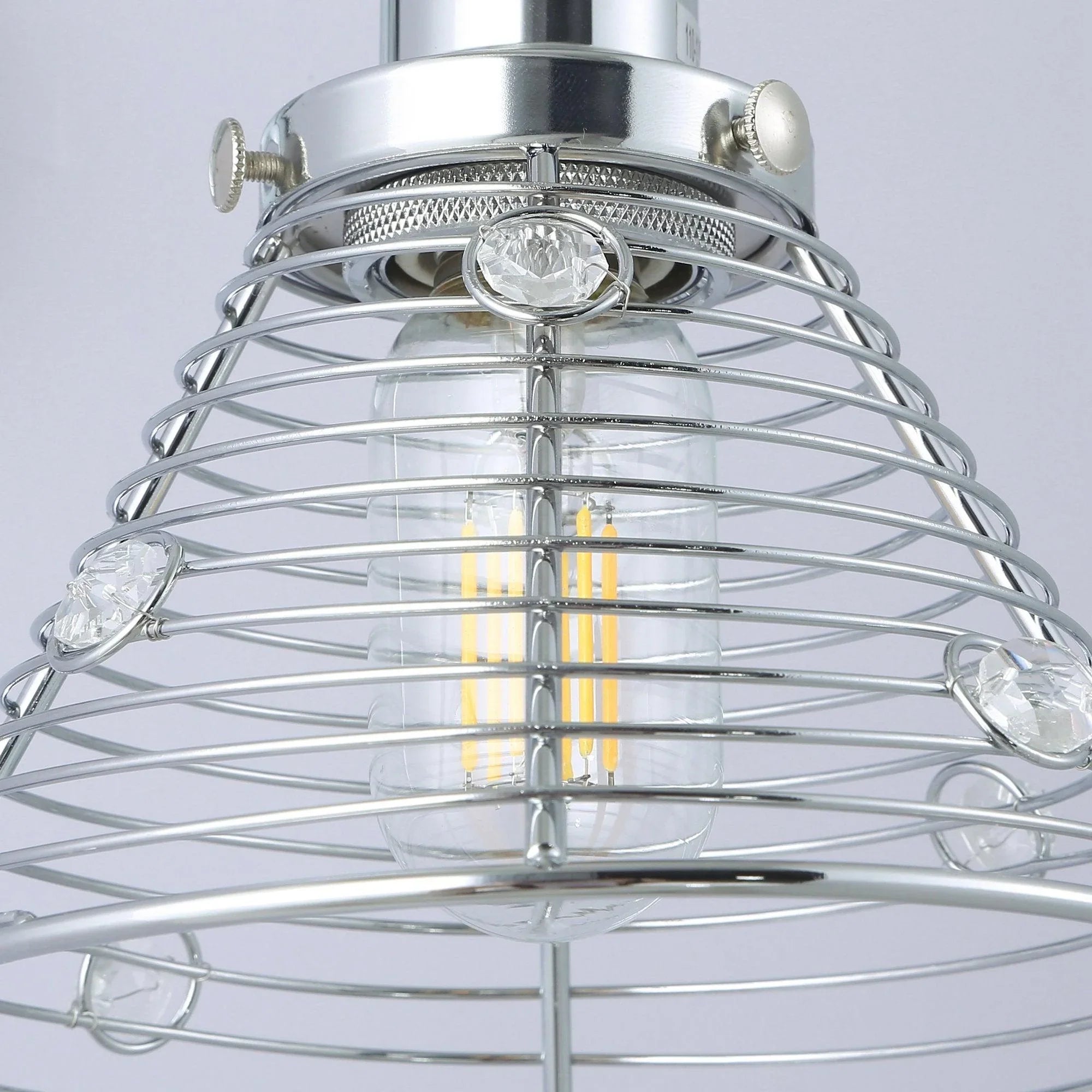 Close view of silver wire cage wall sconce with central socket and clear bulbs