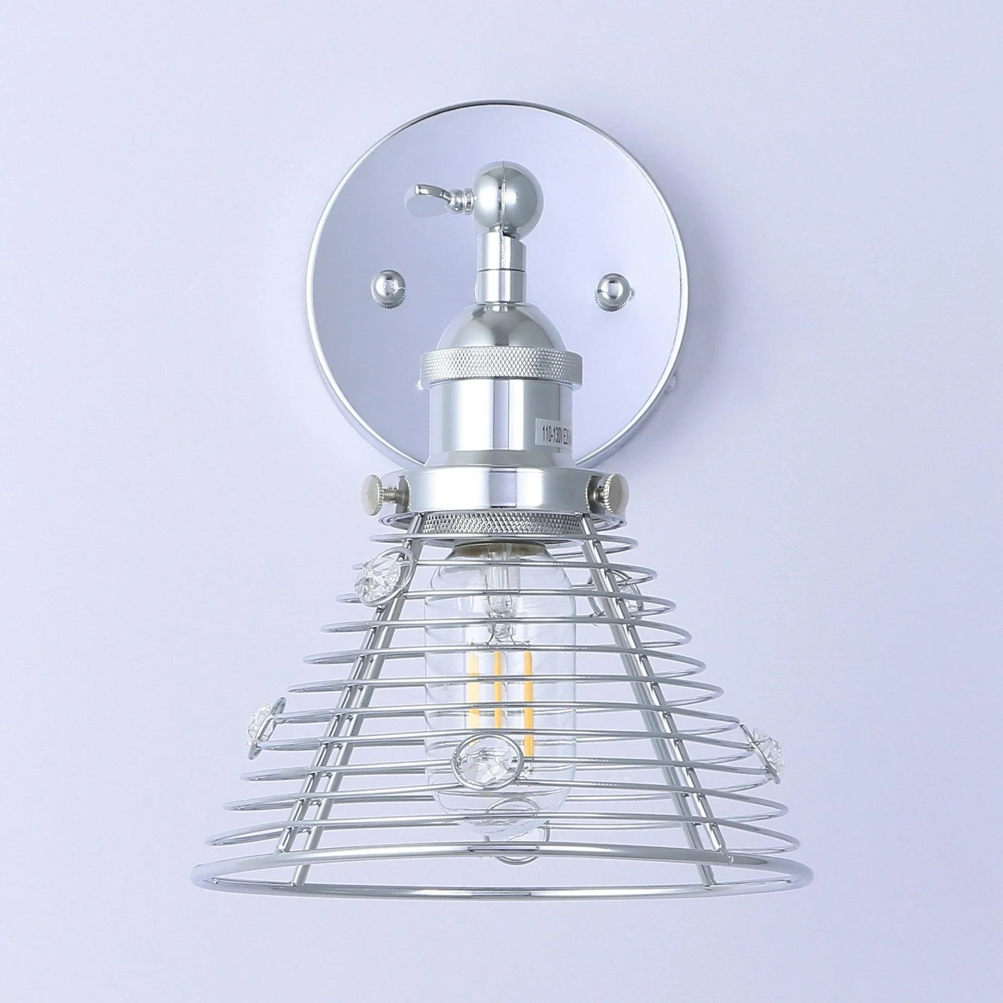 Silver wall sconce with round mounting plate and metal wire cage lamp shade
