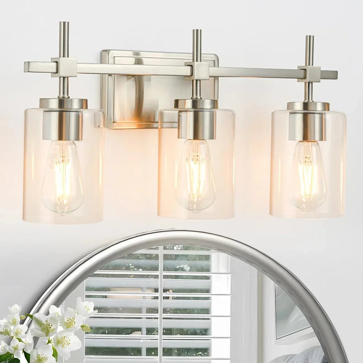 3-light bathroom vanity light with clear glass shades and brushed nickel arms