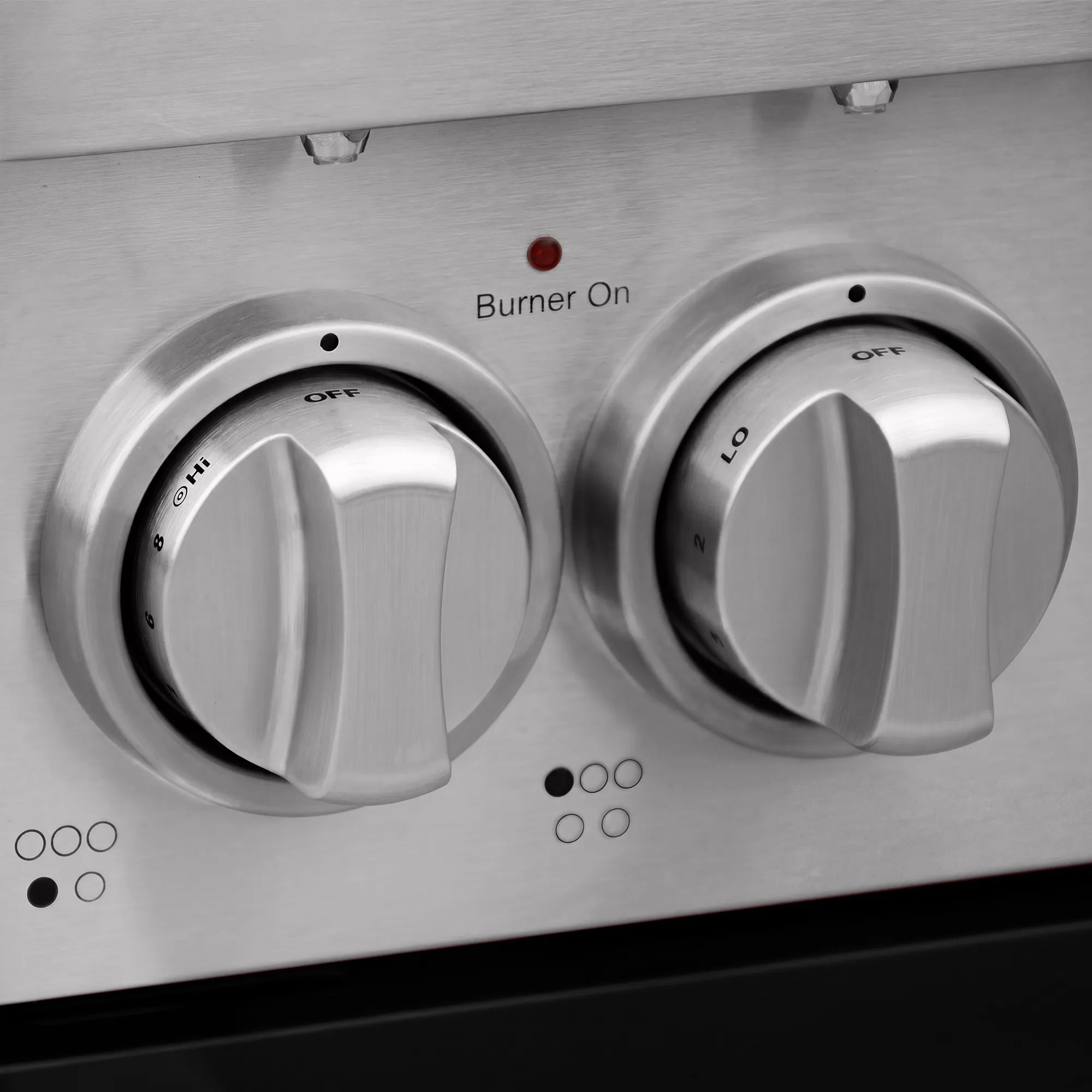 Stainless electric range control knobs labeled Burner On with power settings