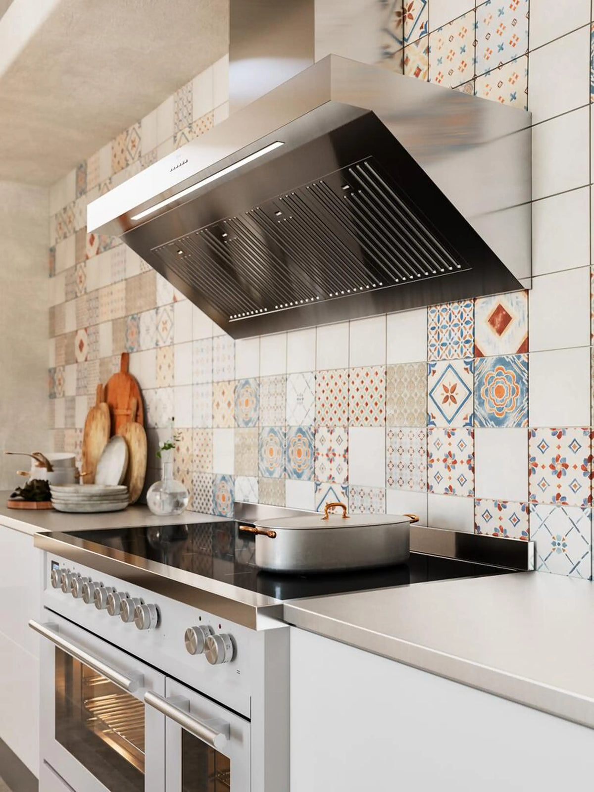 Overhead view of glossy black range hood and induction cooktop surface