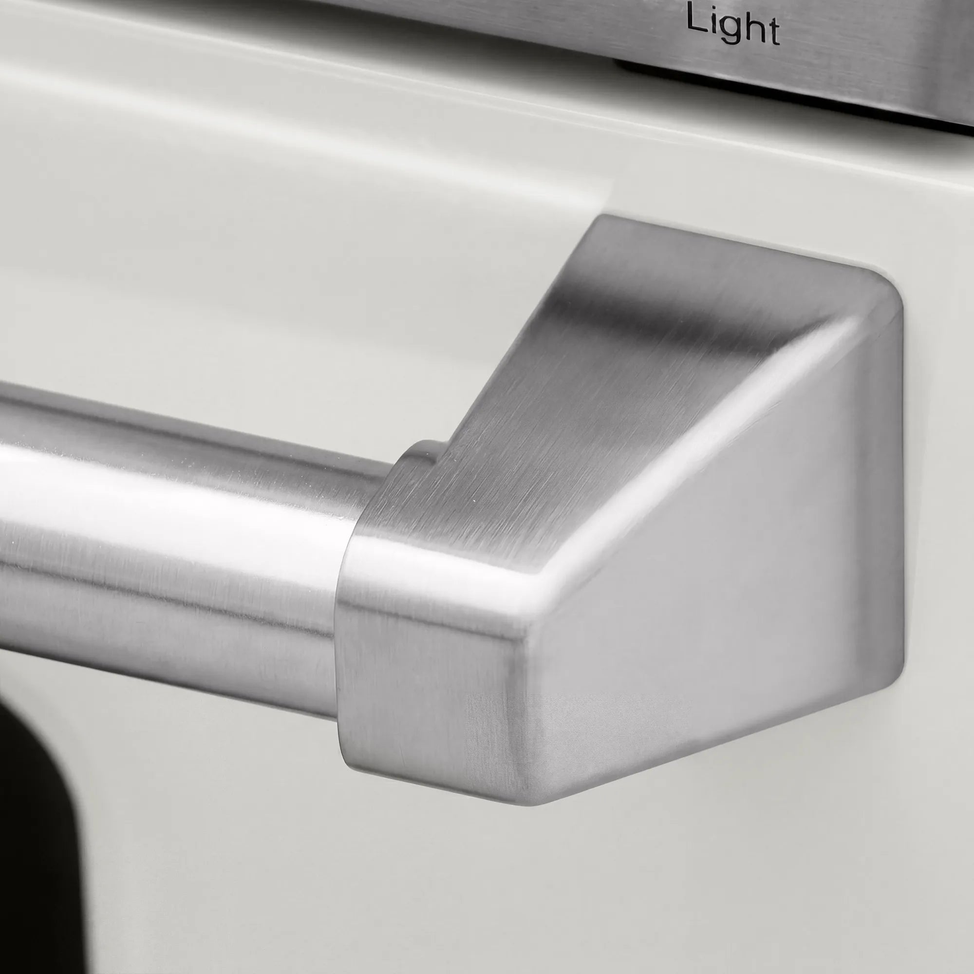 Stainless electric range control area with a large front handle detail