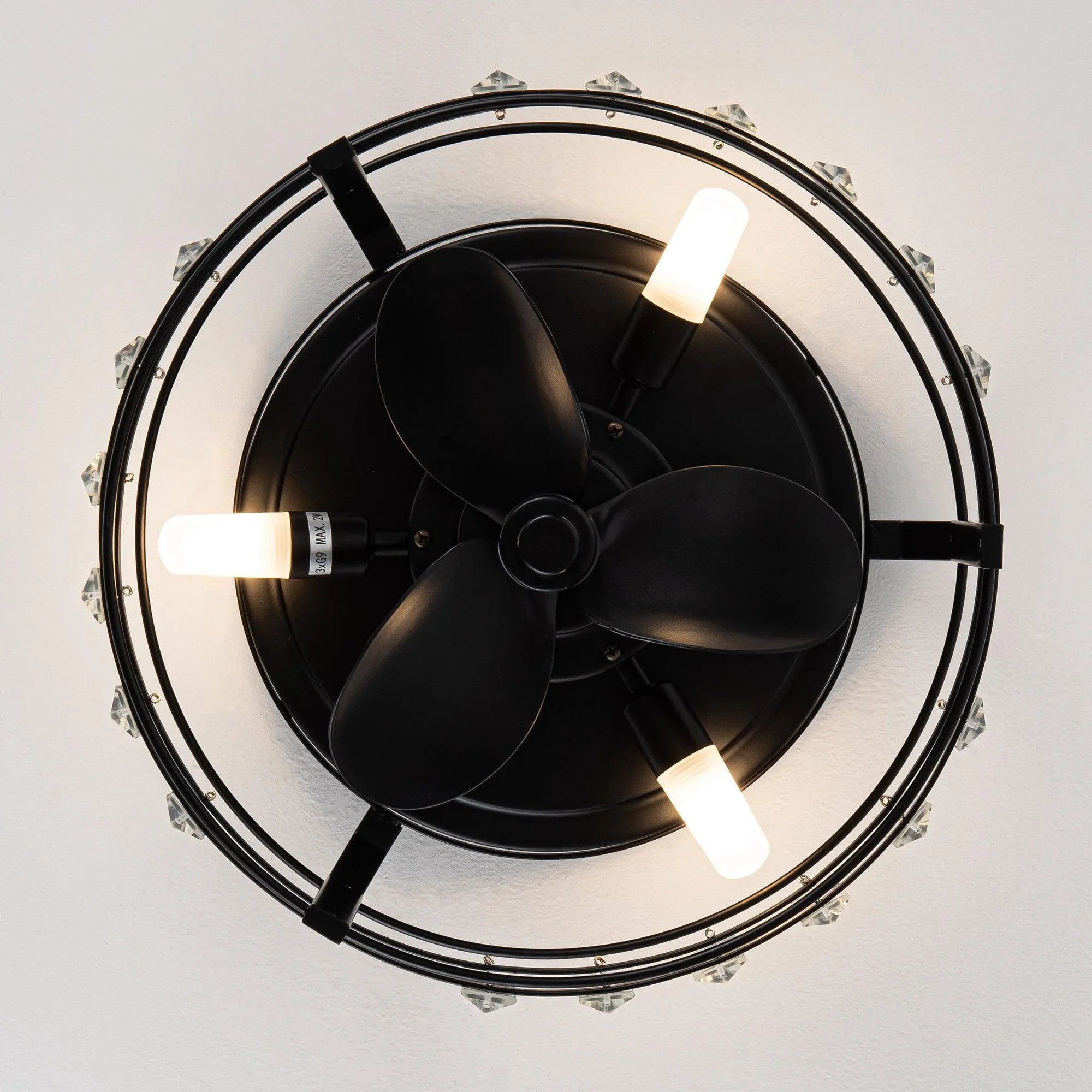 Black ceiling fan with clear crystal ring and visible blades in flush-mount housing