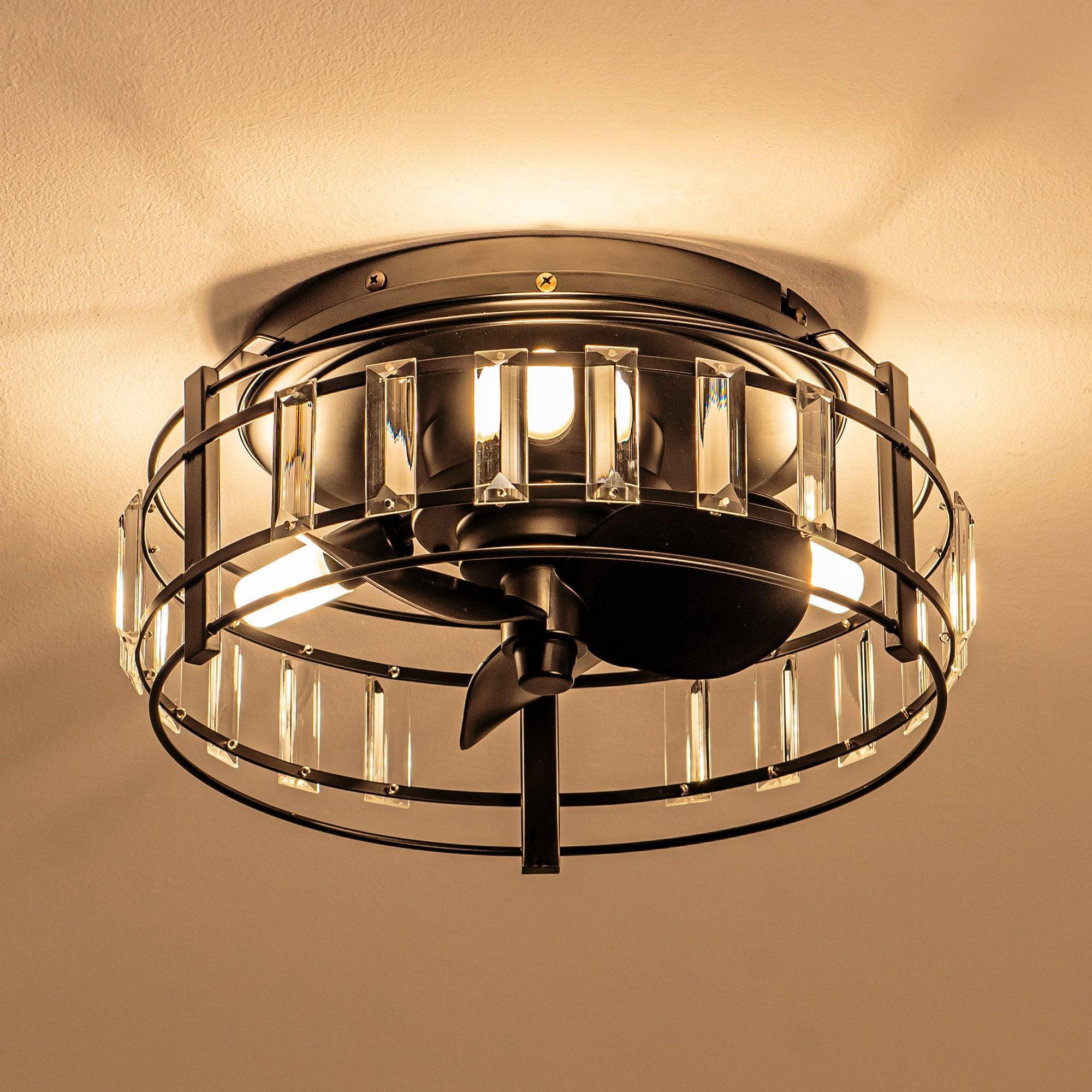 Black flush-mount ceiling fan with clear crystal panels glowing under warm light