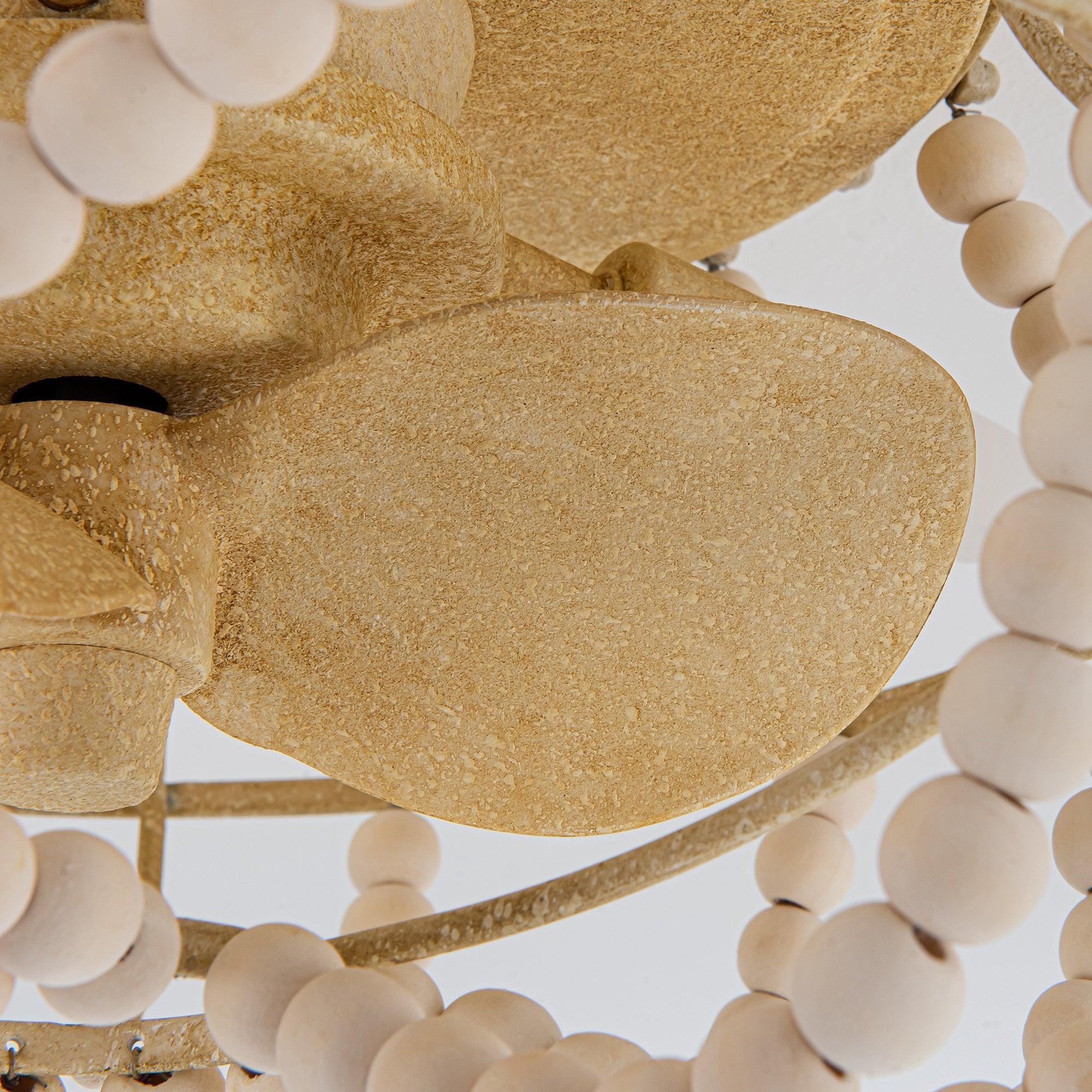Beige fan blade and white beaded strand detail on flush mount ceiling fan