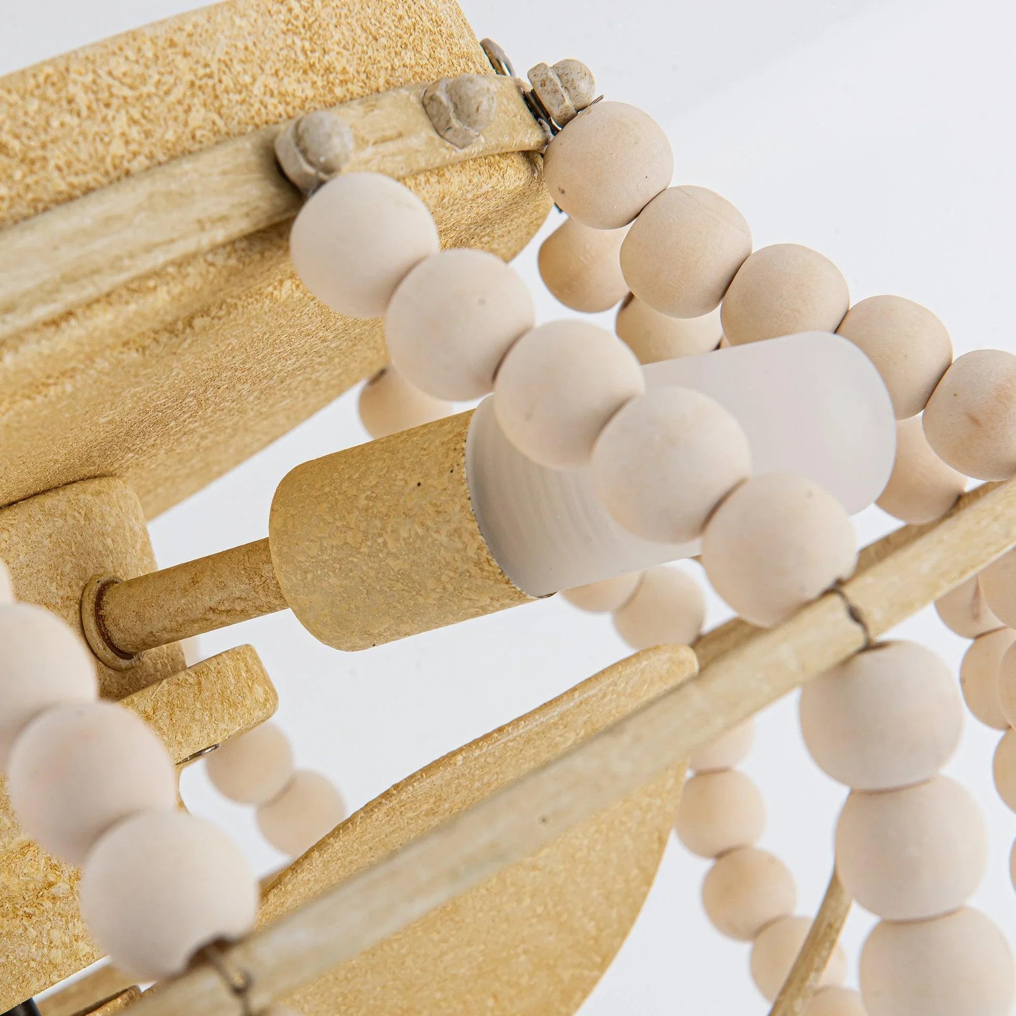 Beige flush-mount ceiling fan light with wooden bead trim and scroll-style mounting