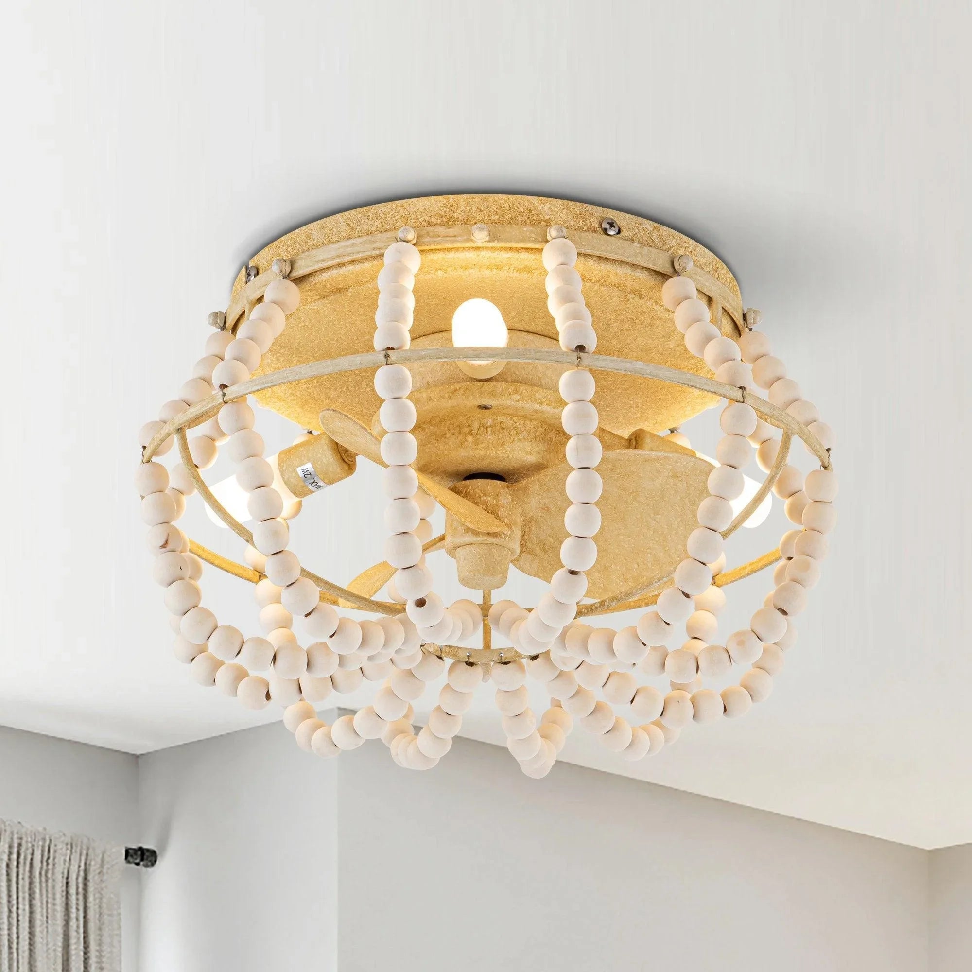 Beige flush-mount ceiling fan light with beaded ring and fan blades behind glass