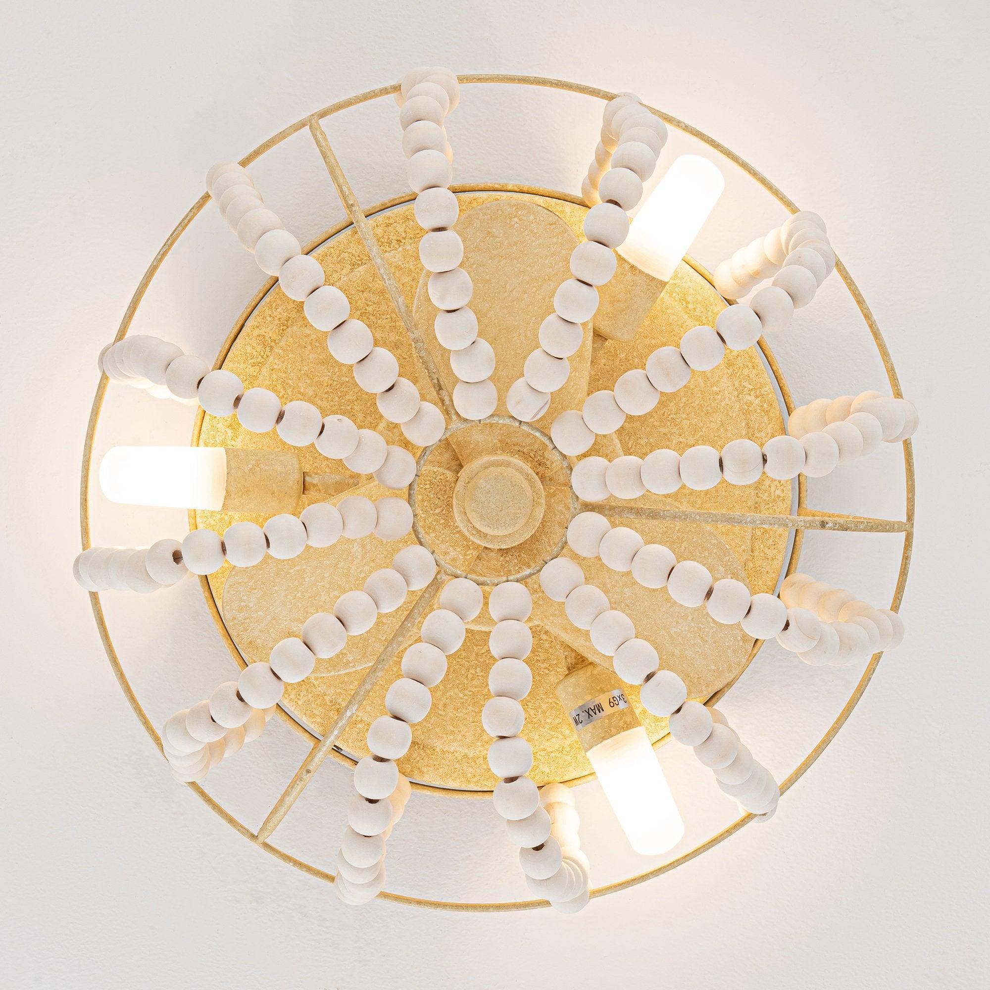 Beige flush mount ceiling fan with lighting and circular grille with white bead accents