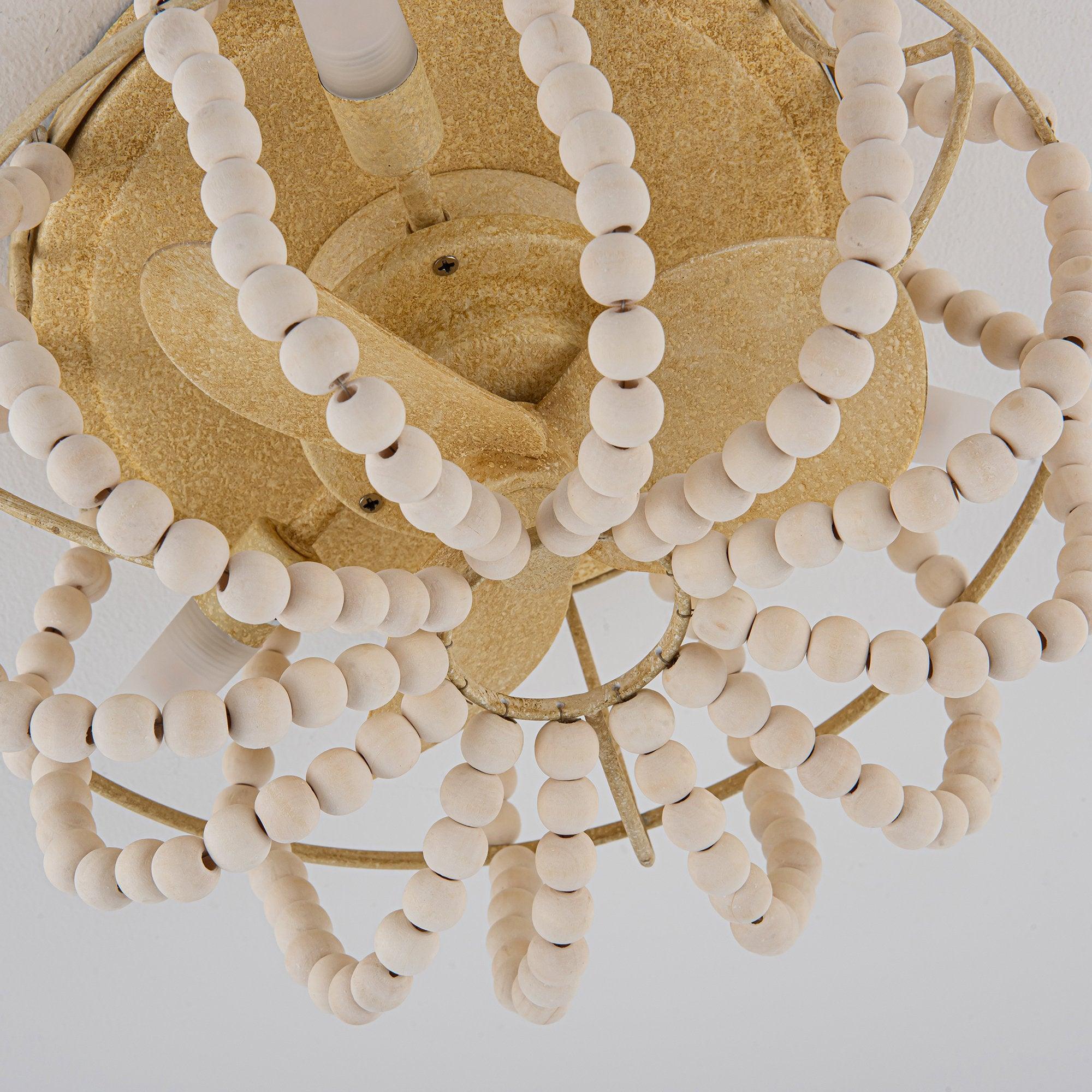 Beige ceiling fan with decorative white beaded strings and metal fan blade supports