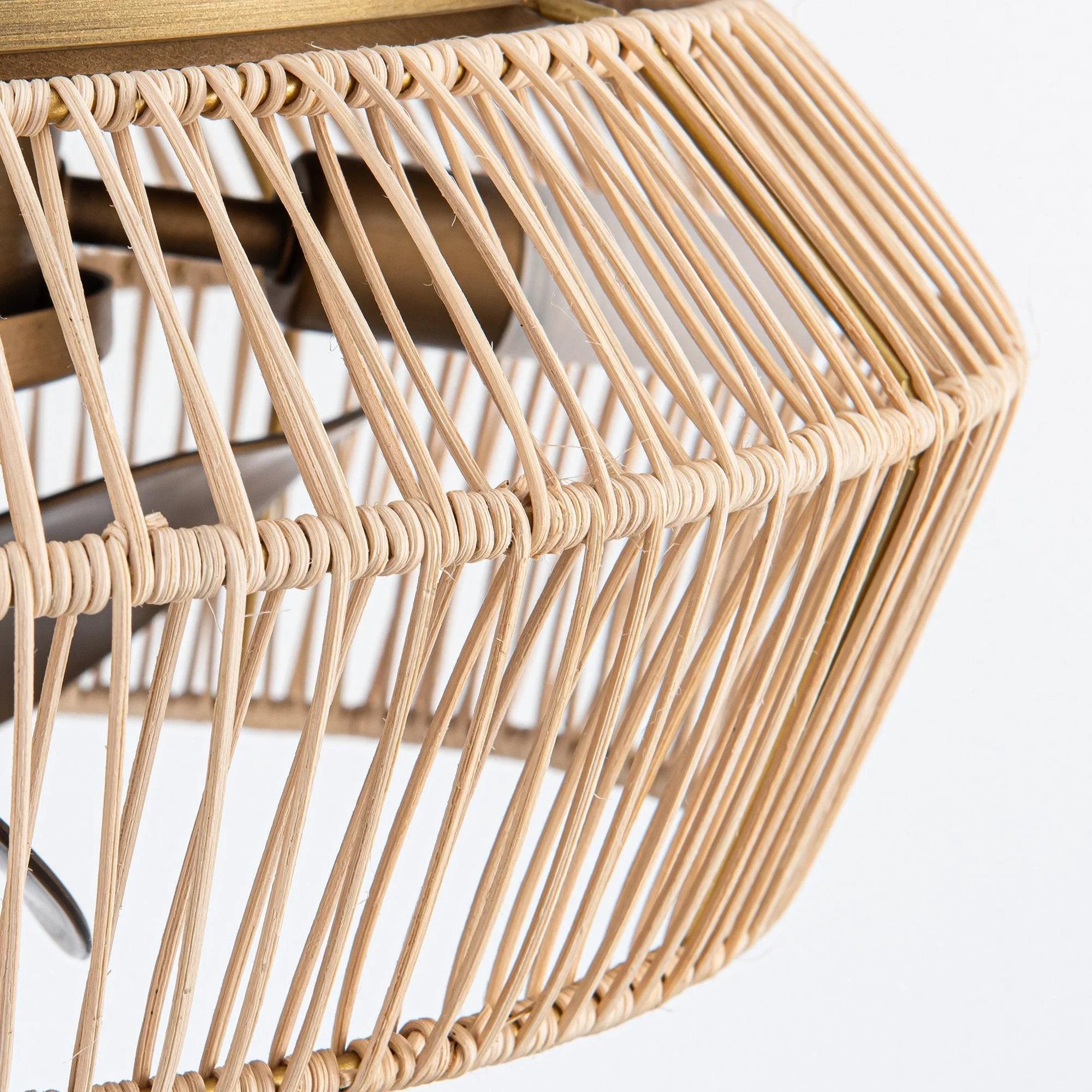 Golden rattan-style fan cage with evenly spaced vertical strands and curled rim