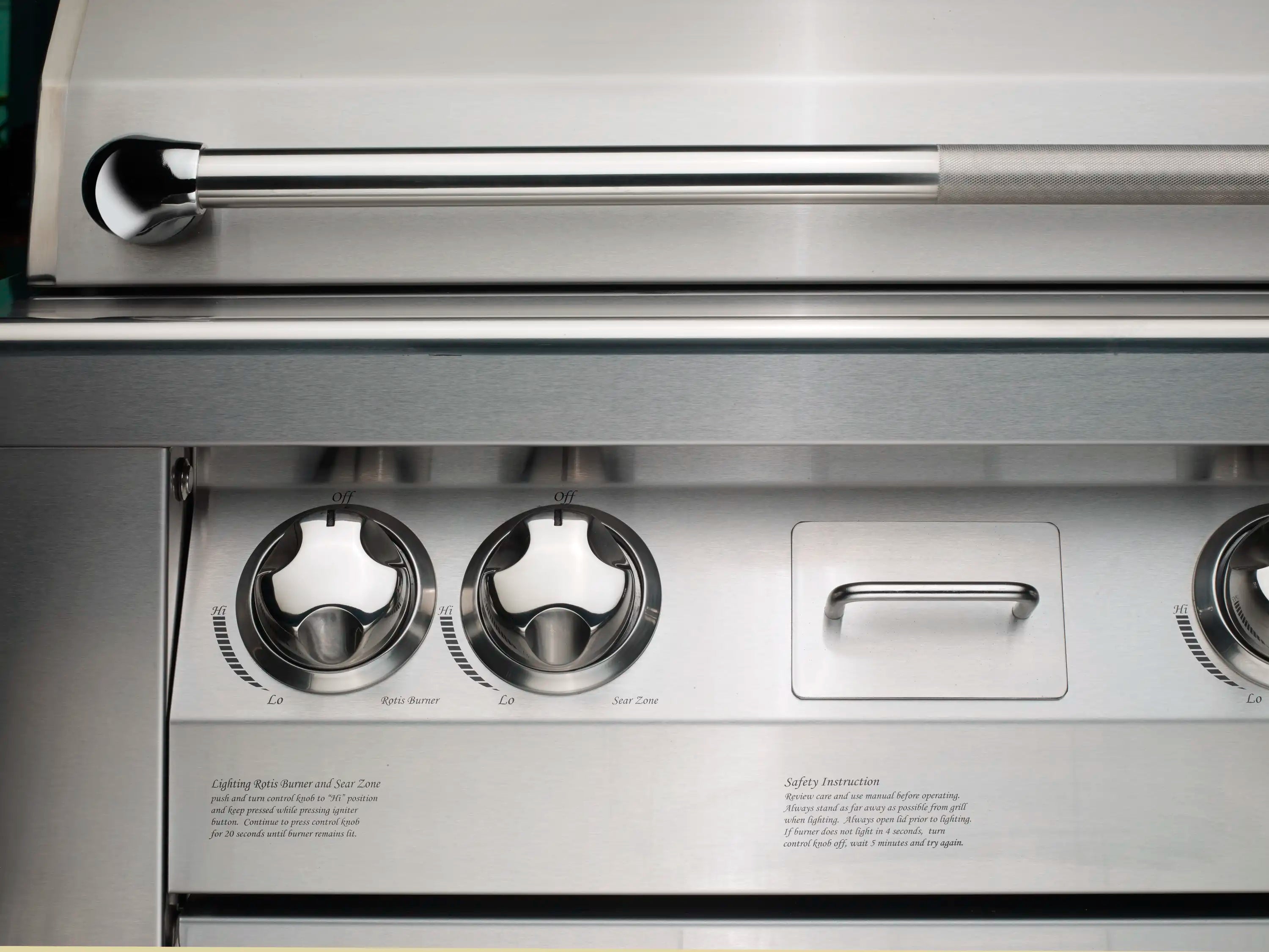 Stainless steel natural gas grill control panel with three knobs and a handle