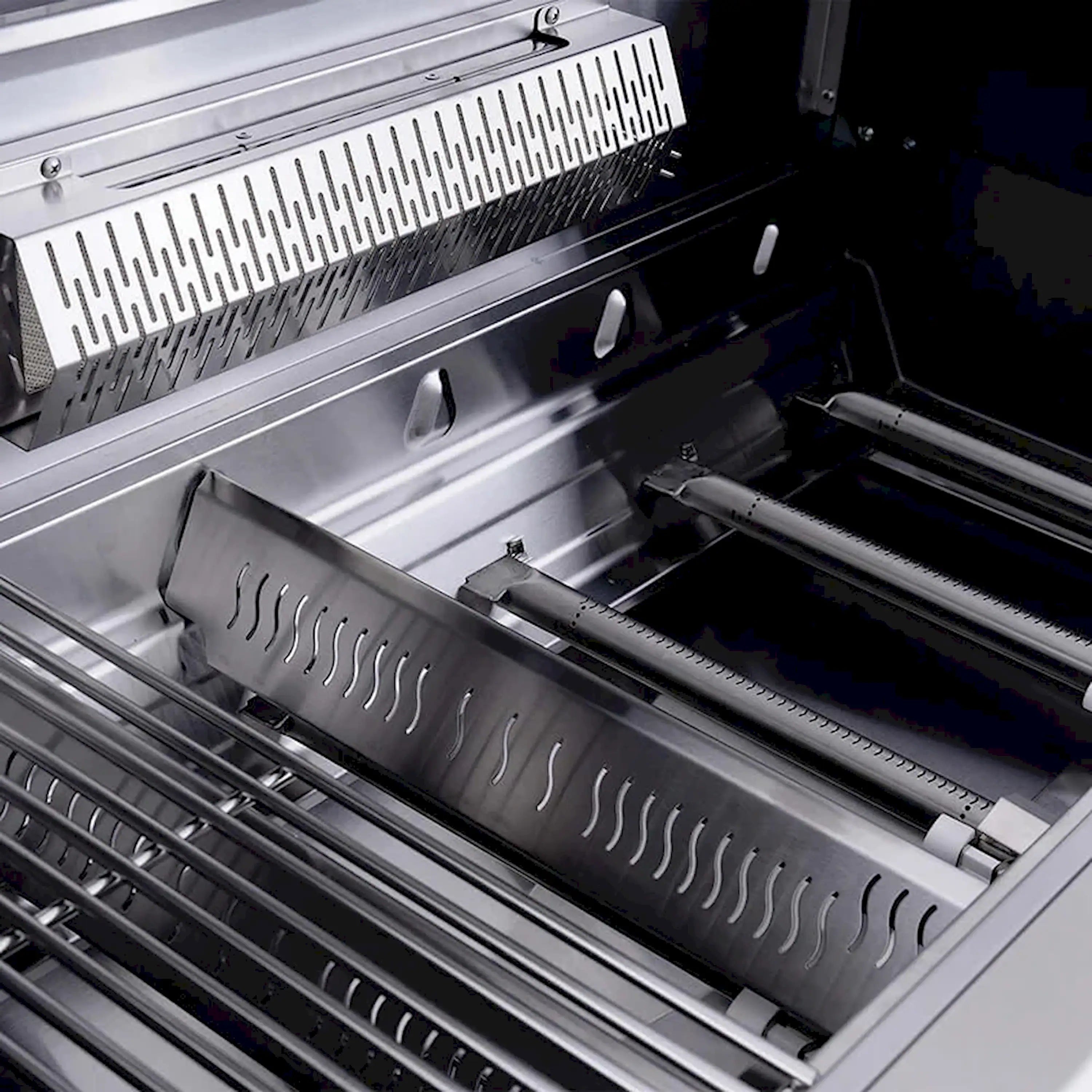 Open grill interior with stainless sear burner cover and grill rails