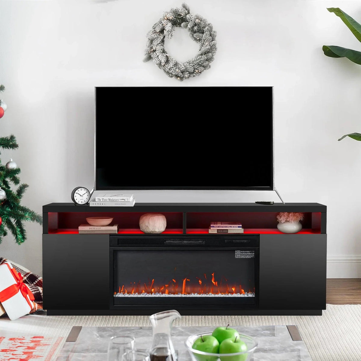 Black TV stand with electric fireplace insert and open media shelves across the top edge.