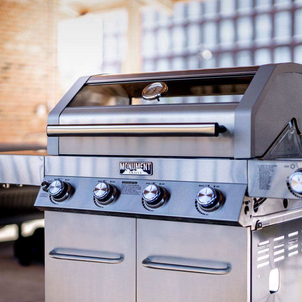 Stainless steel gas grill front panel with burner knobs and lid handle