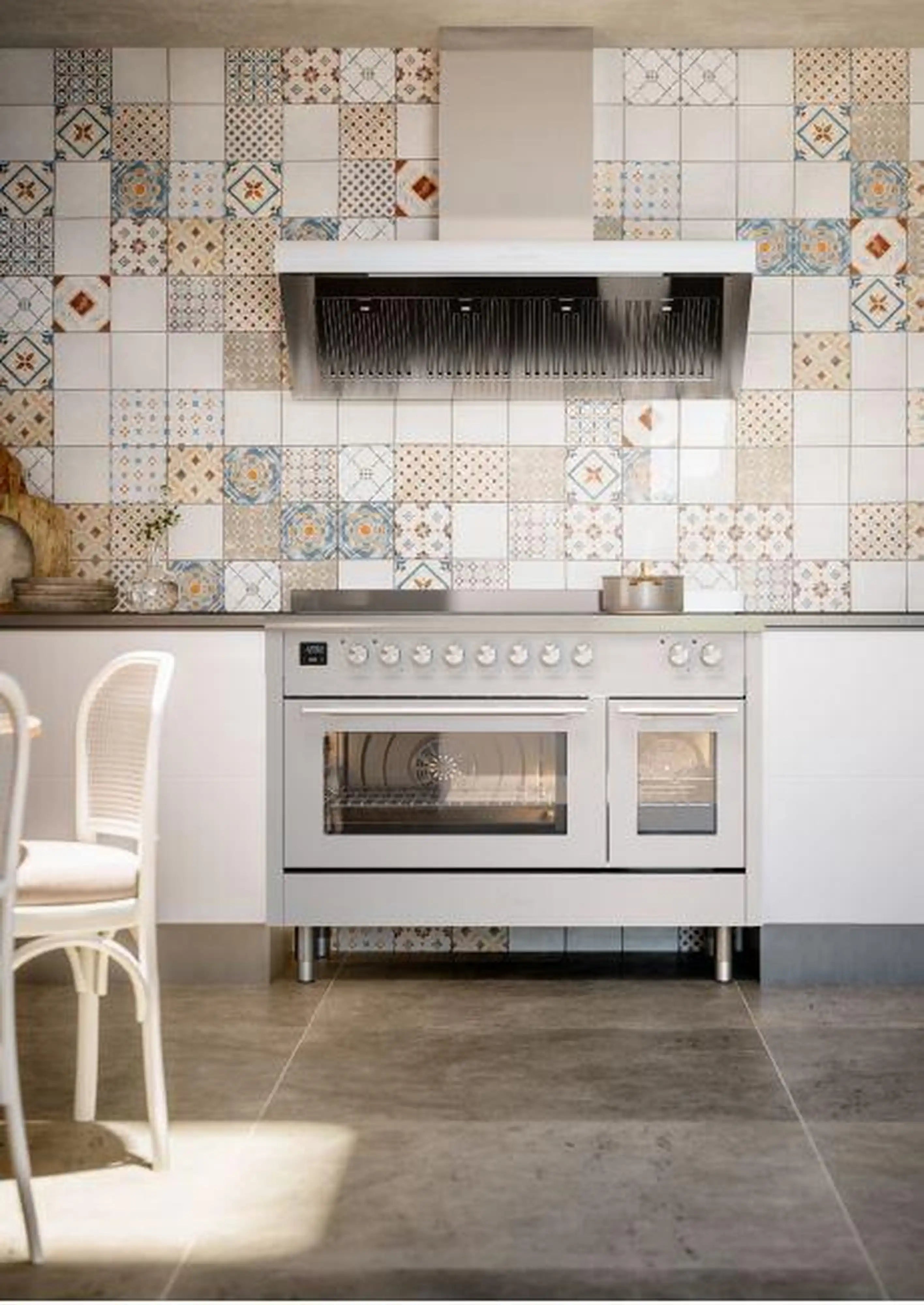 White freestanding dual-fuel range installed in a kitchen with tile backsplash