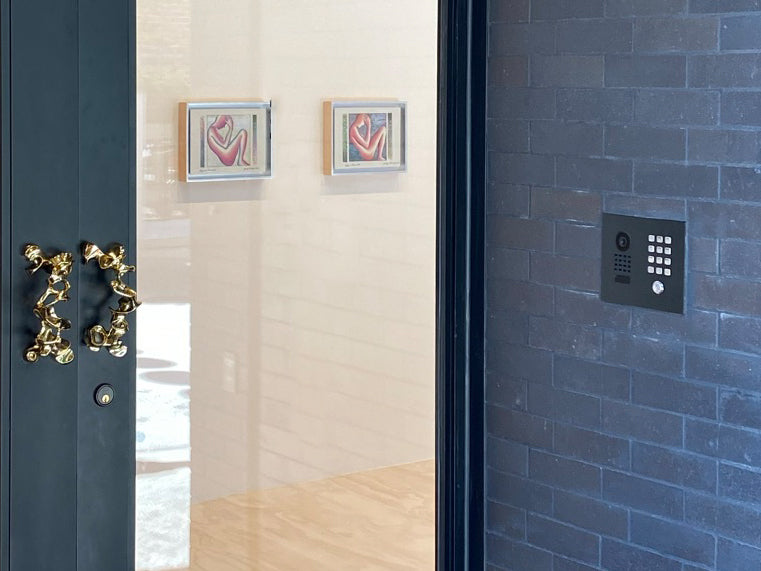 Flush-mount IP video door station with keypad and camera on exterior wall