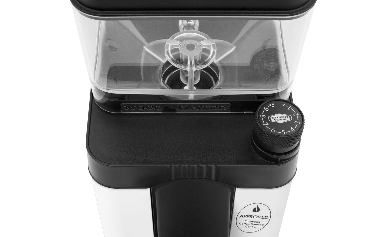 Matte white coffee burr grinder with clear hopper and black grind setting dial, close-up.