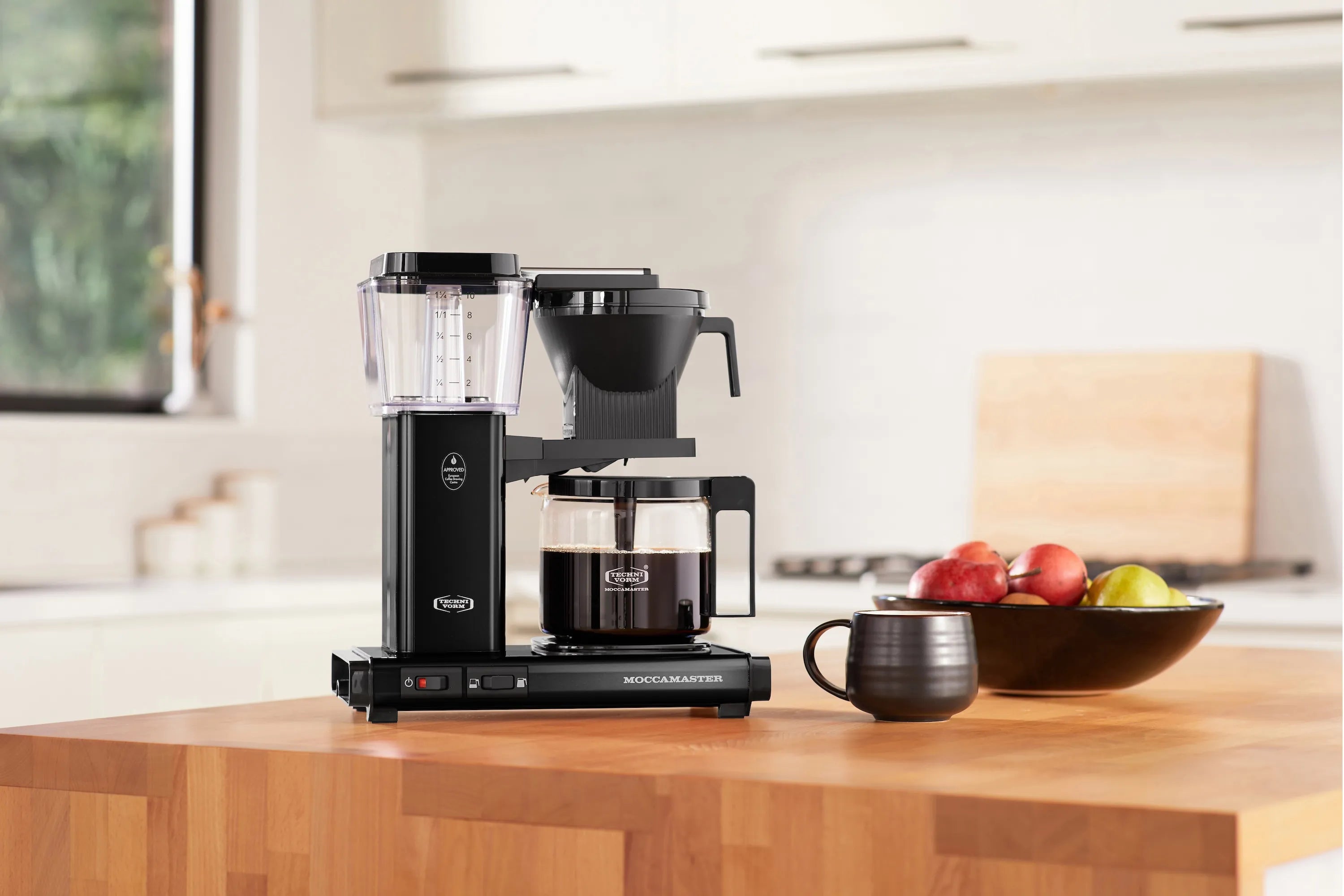 Black Moccamaster drip-stop coffee maker with glass carafe and water level window