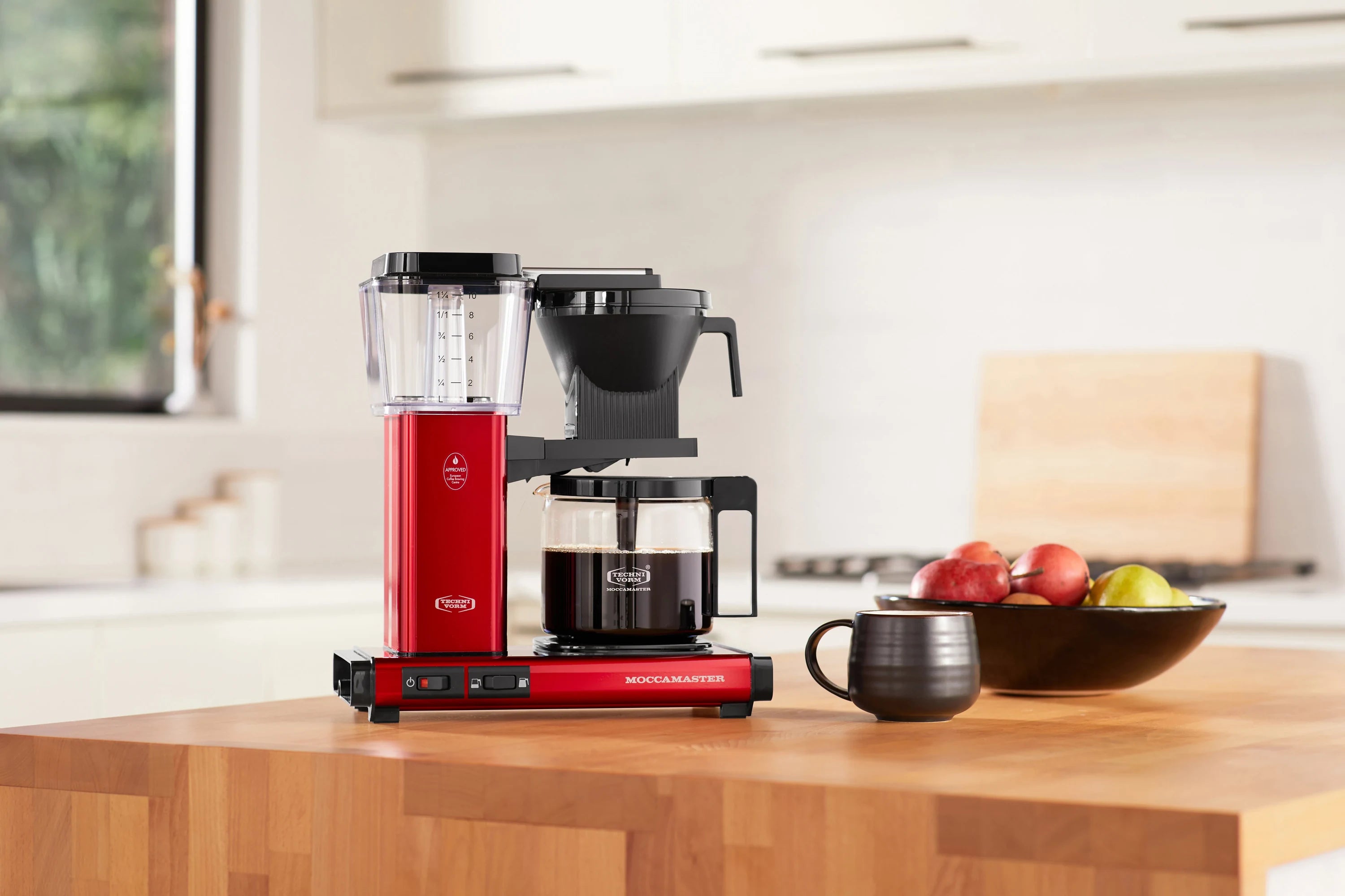 Candy apple red coffee maker with clear water reservoir and glass carafe