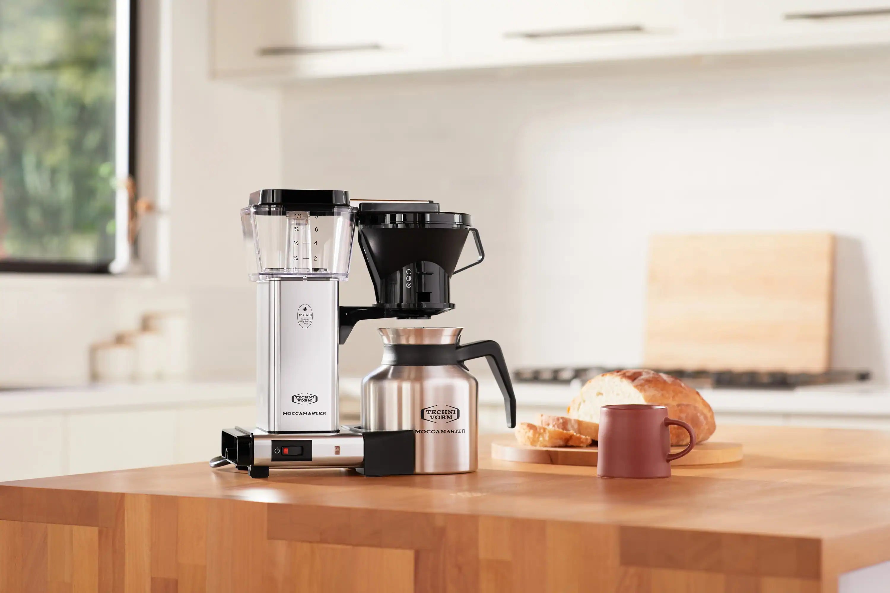 Thermal carafe coffee maker in polished silver and black with front control panel