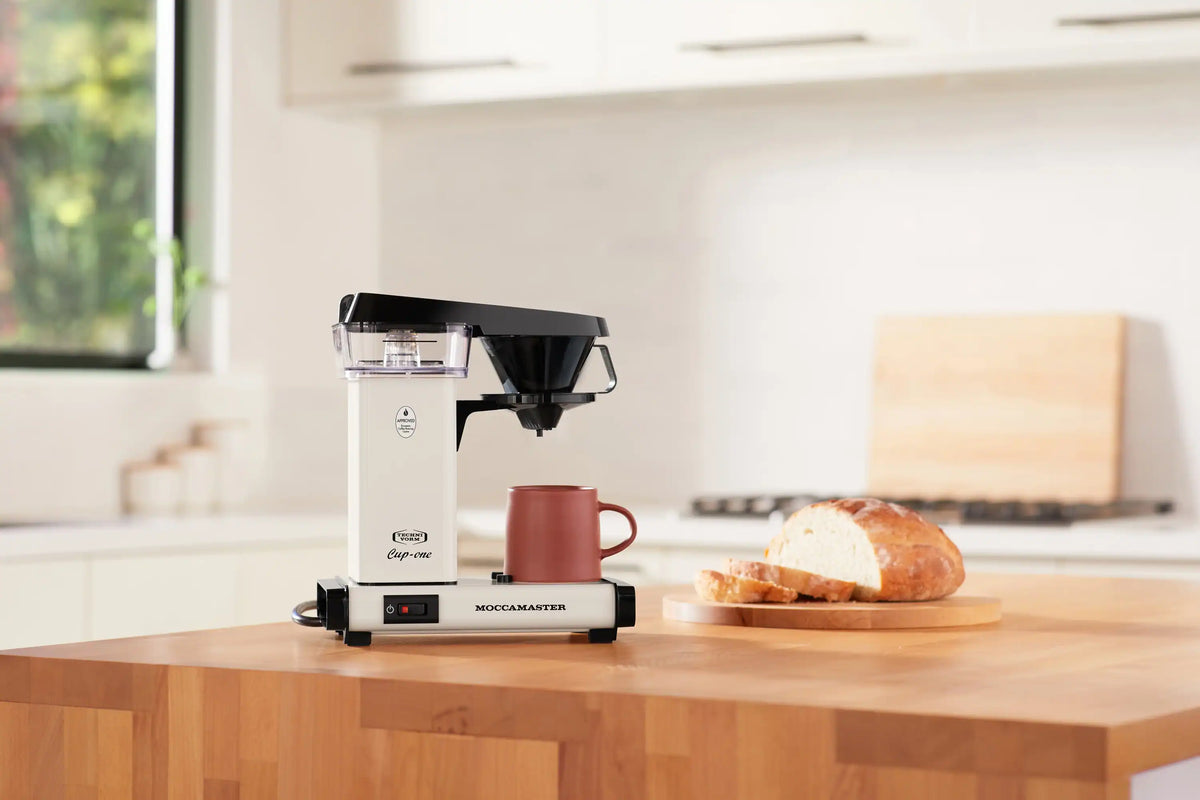 Off-white Moccamaster Cup-One single coffee maker with black spout beside red mug