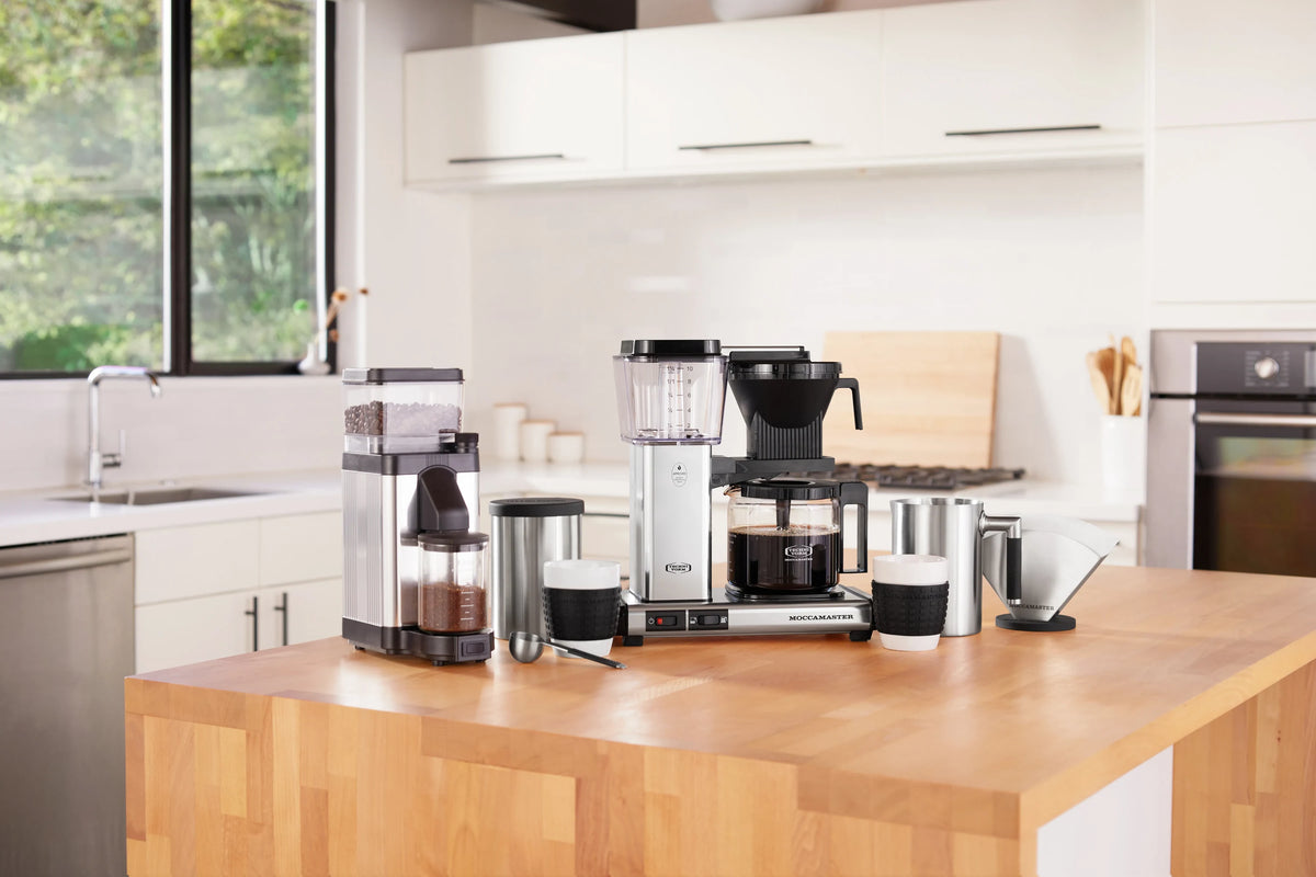 Polished silver burr grinder with black hopper lid and adjustable grind outlet