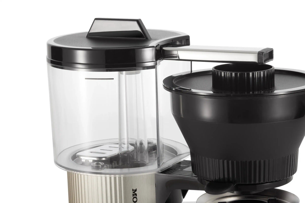 Brushed silver coffee maker brewing unit with black filter basket and clear reservoir