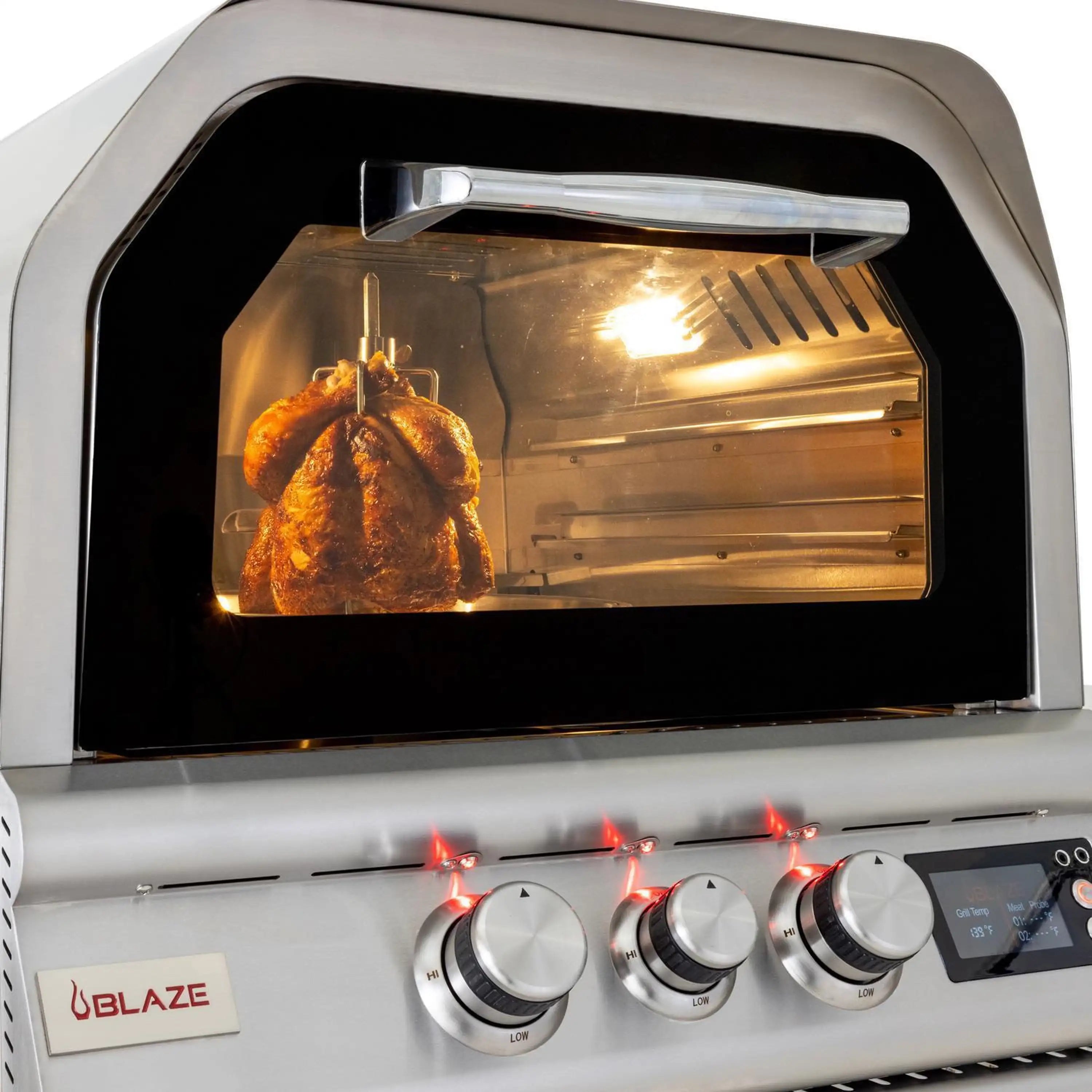 Countertop propane pizza oven with rotisserie chicken inside, glass viewing lid open