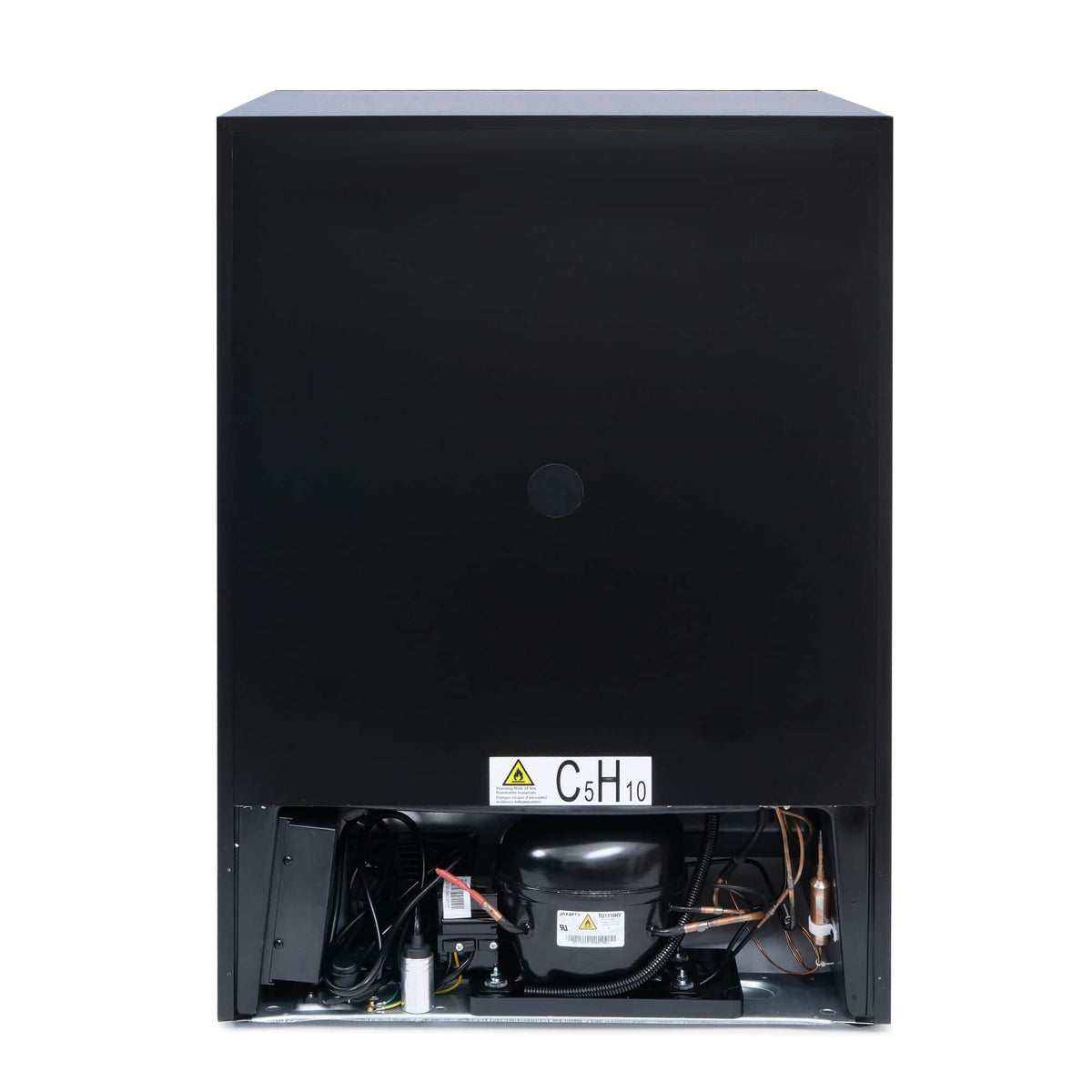 Refrigerator base with exposed compressor, coils, and wiring behind the front panel