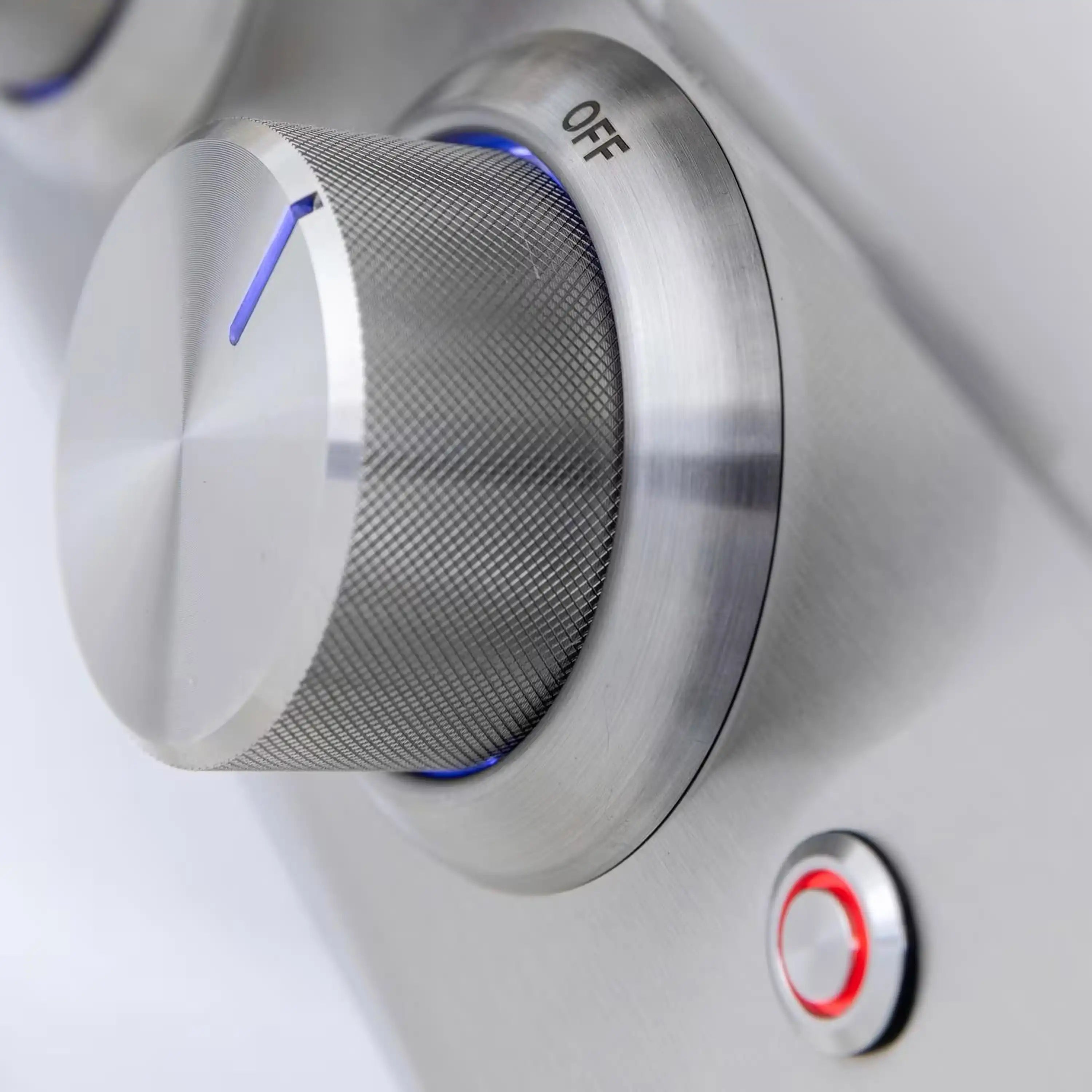 Rotary grill control knob labeled OFF and ON with blue accent light strip