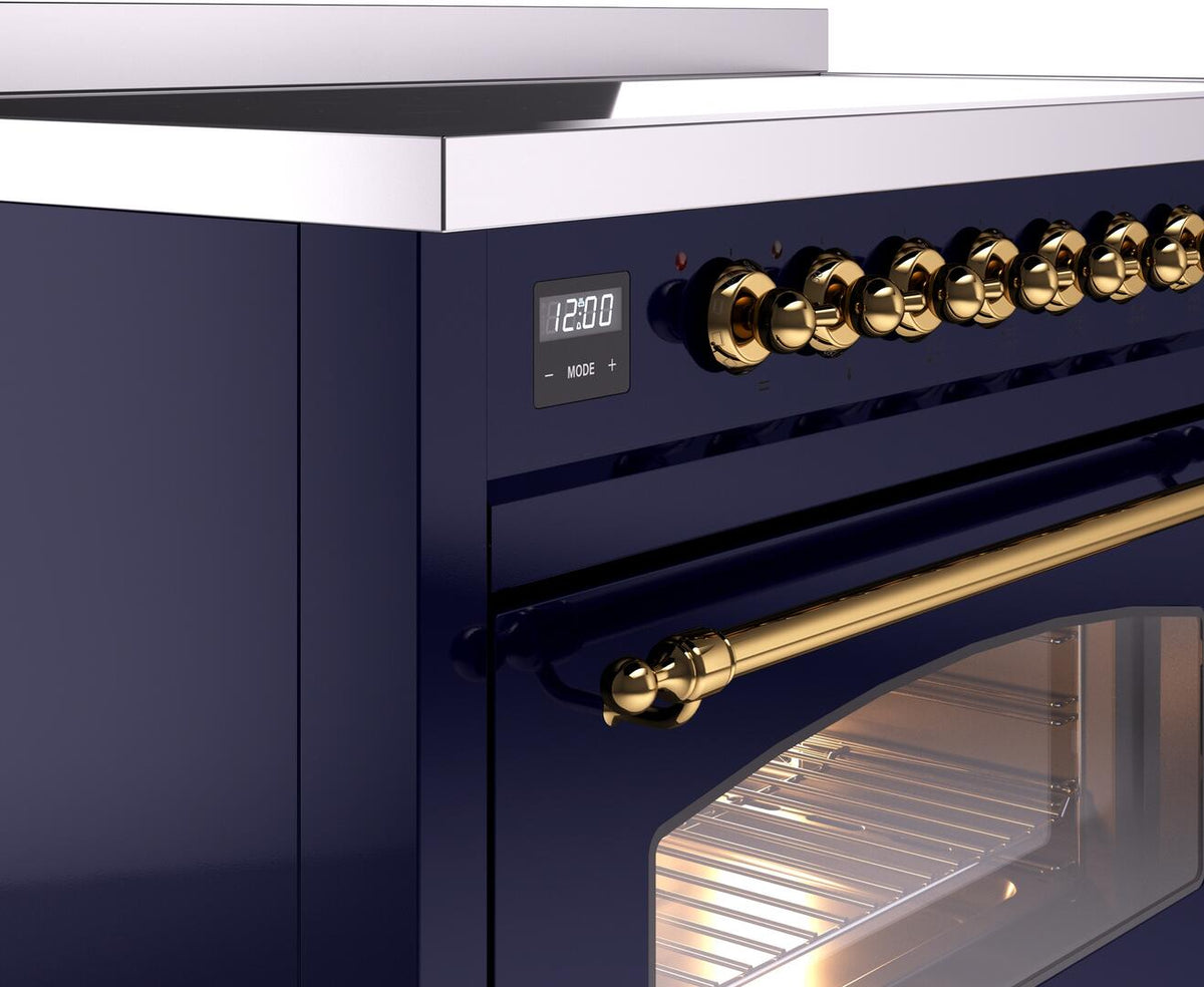 Midnight blue range front panel with brass control knobs and lit oven opening