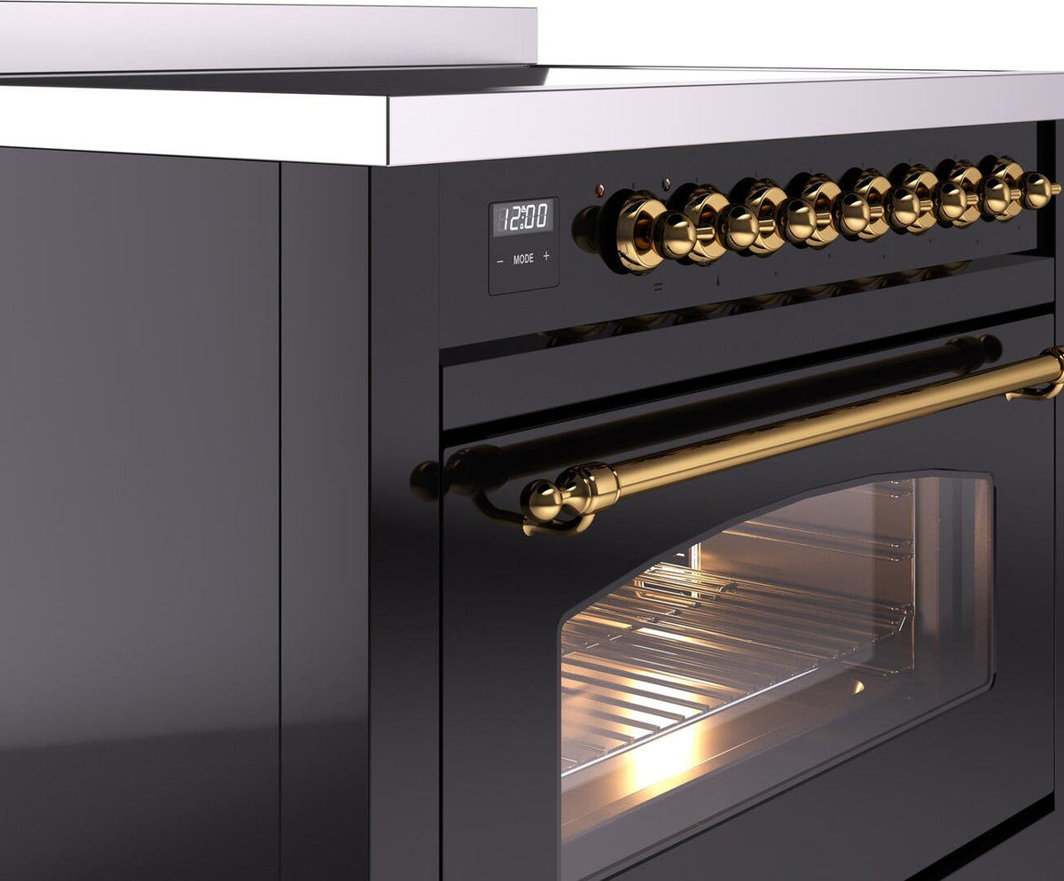 Freestanding induction range control knobs and brass oven handle on glossy black