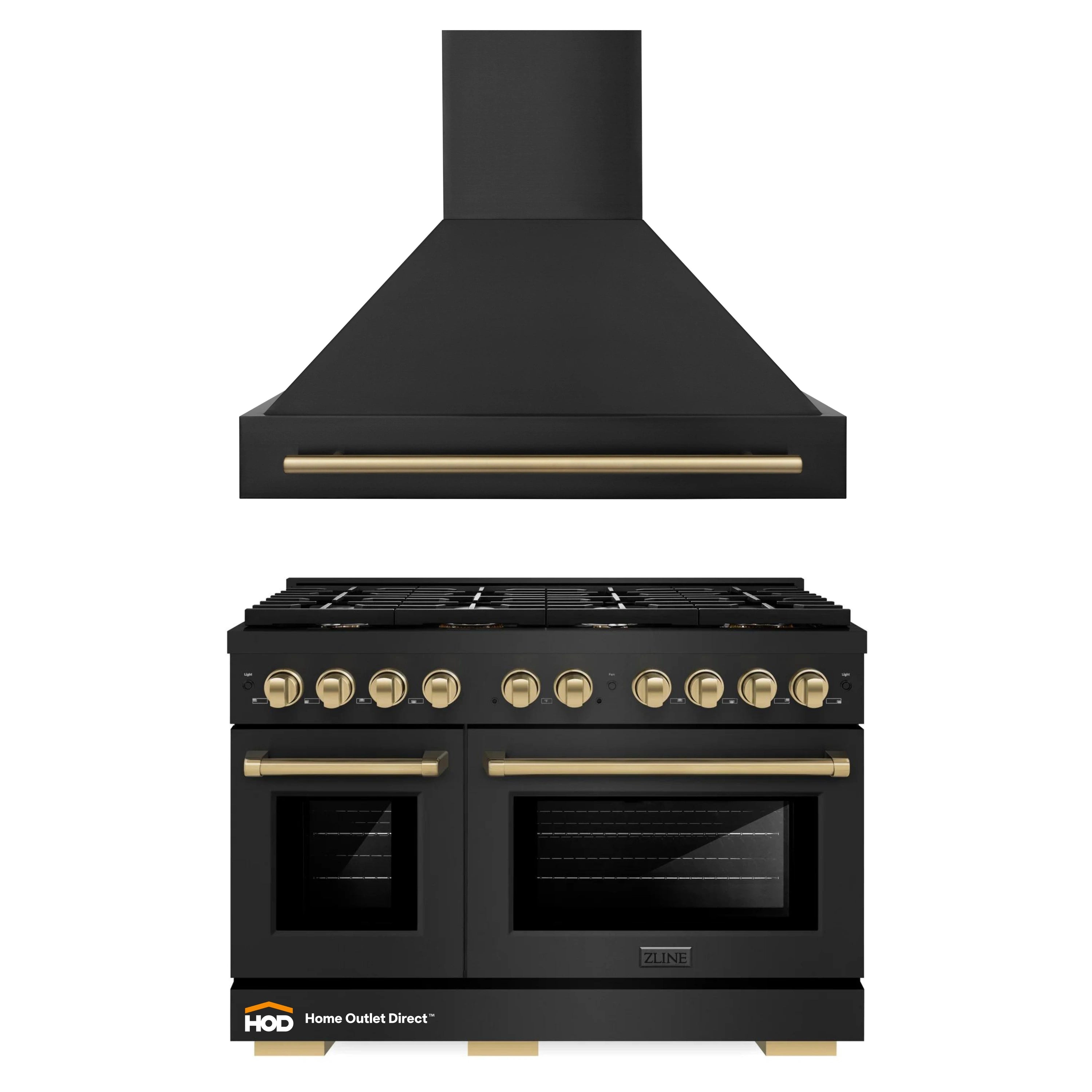 Black wall range hood and black gas range with brass controls and bronze trim