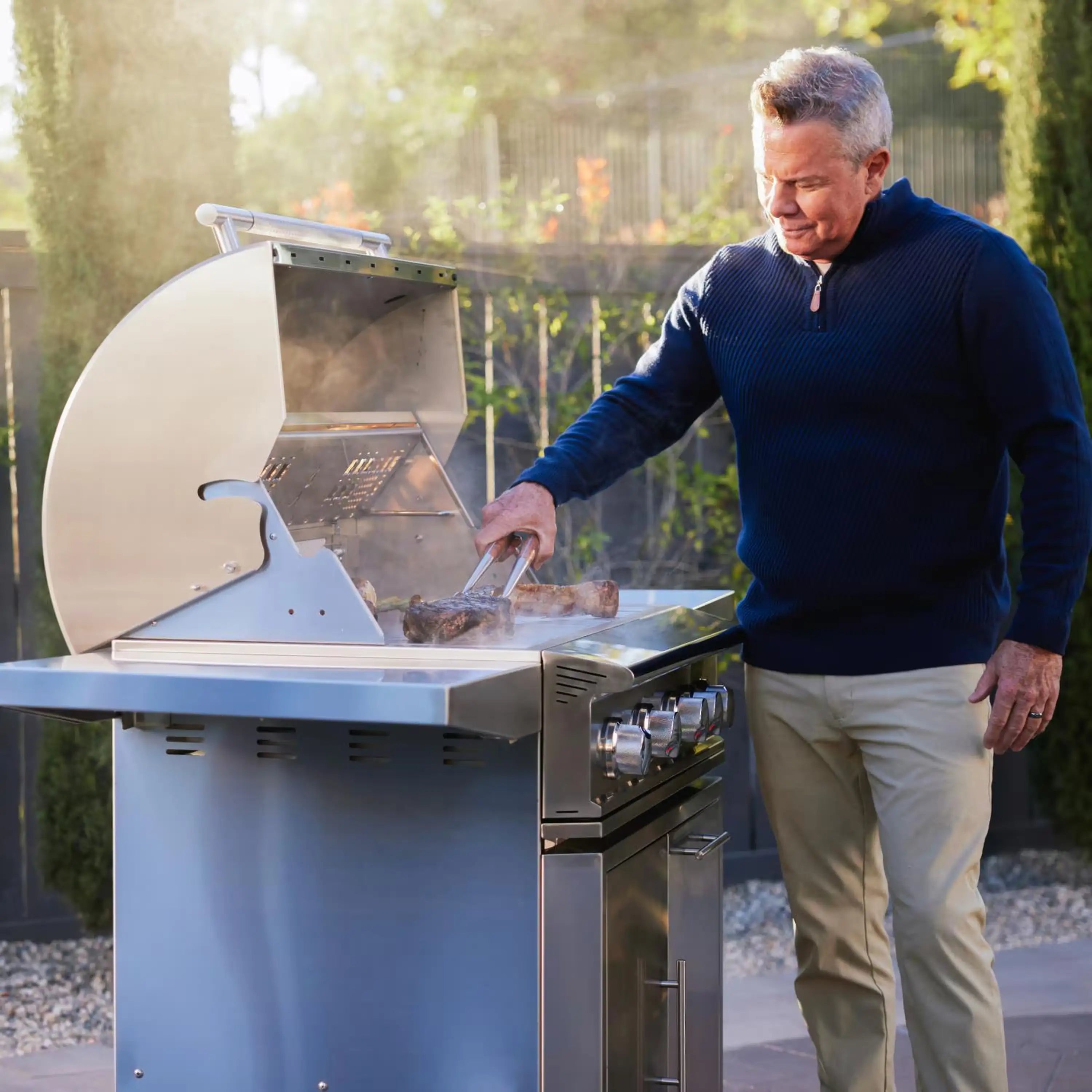 Stainless steel Blaze gas grill cart with open lid and side shelves