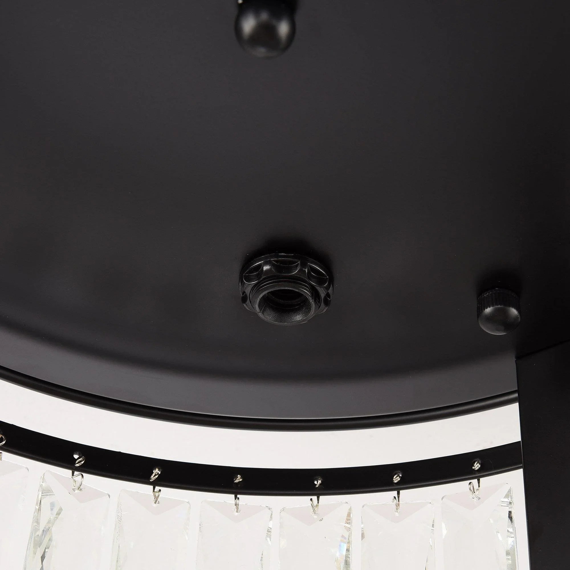 Close-up of black ceiling canopy with open lamp sockets below