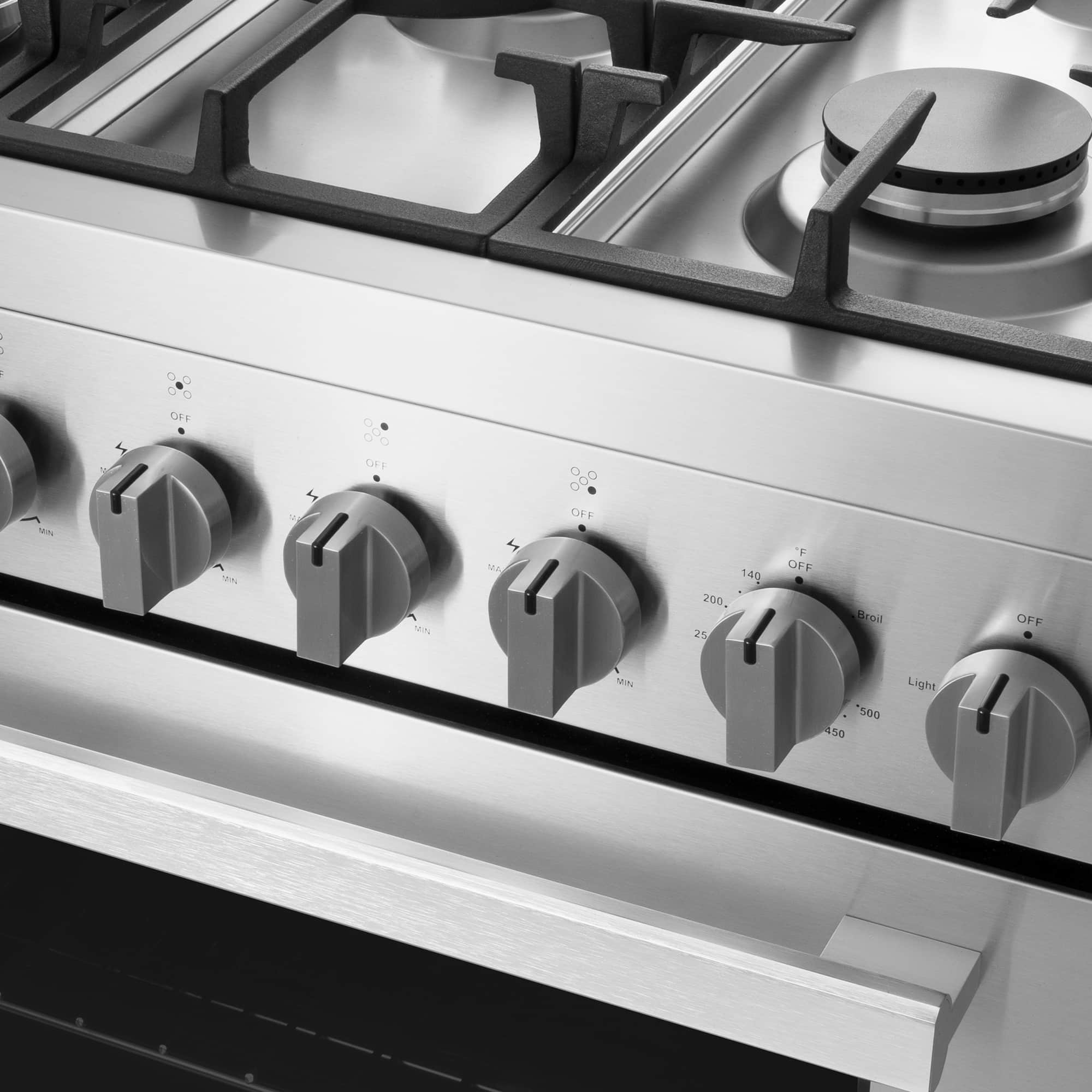 Stainless gas range cooktop control panel with four burner knobs