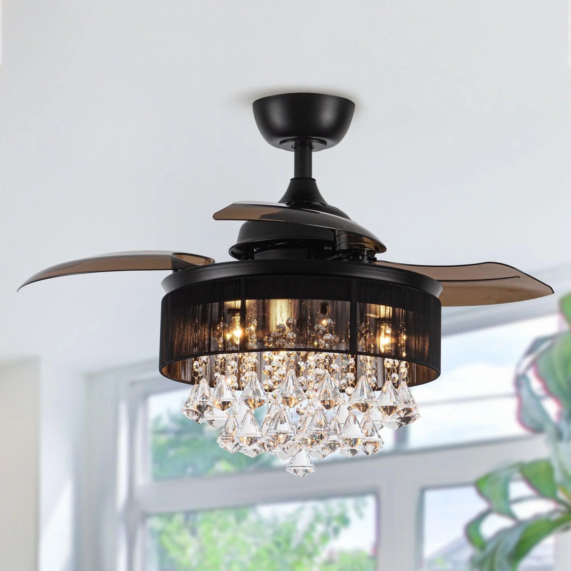 Black crystal ceiling fan with wood-toned blades and glowing chandelier-style light