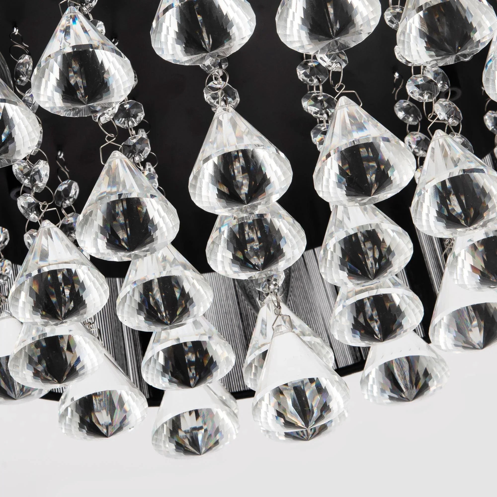 Hanging clear crystal teardrop ornaments with metal links, close-up