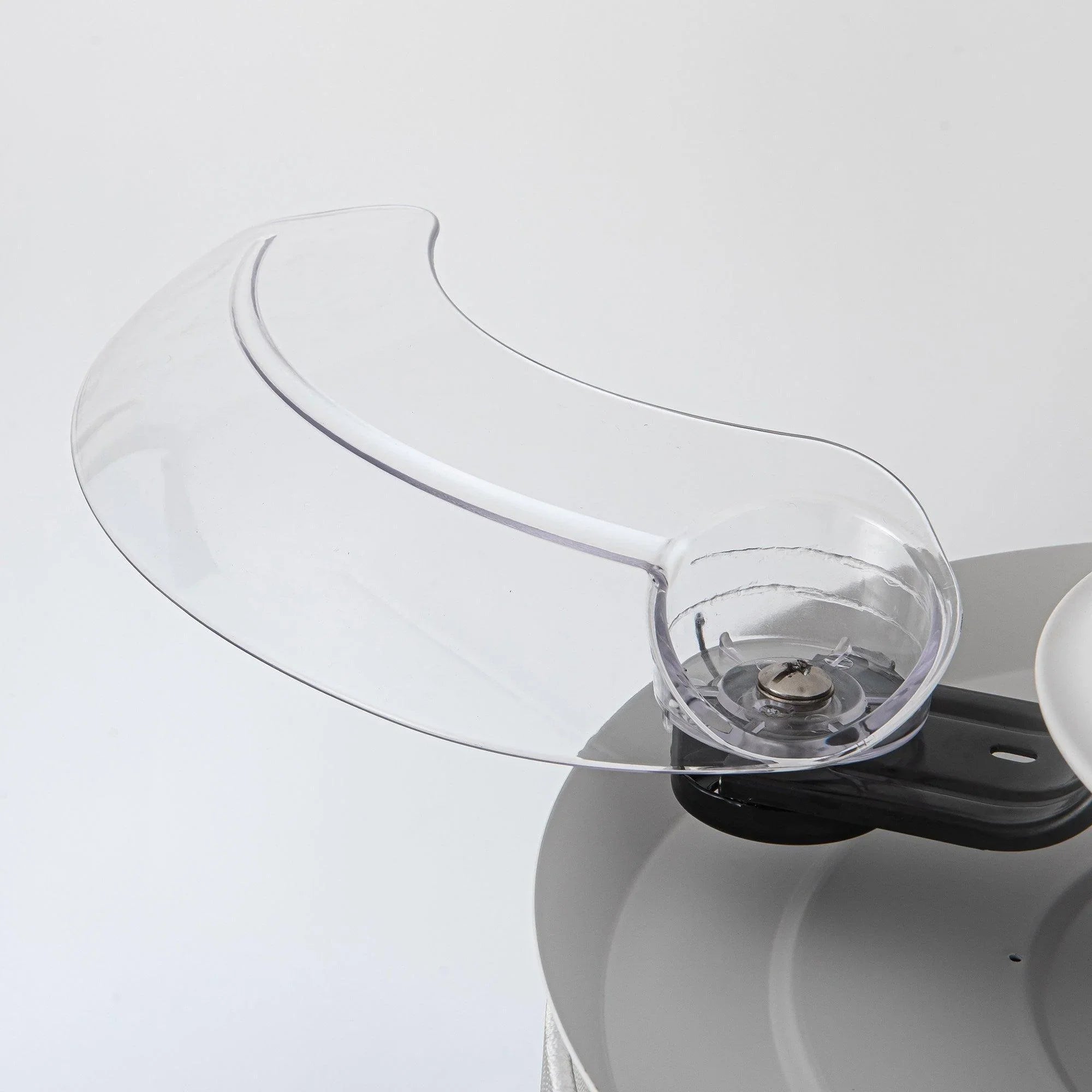 Crystal ceiling fan light glass globe on a black motor housing, with blade edge visible