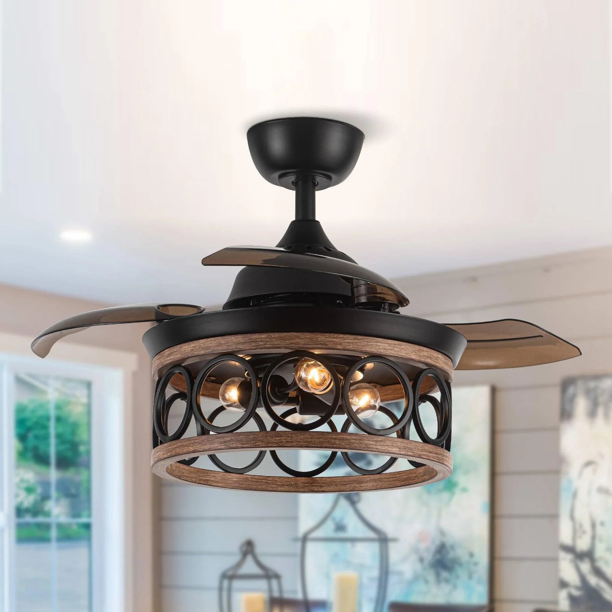 Black ceiling fan with caged lamp light and wood-toned blades, glowing bulbs