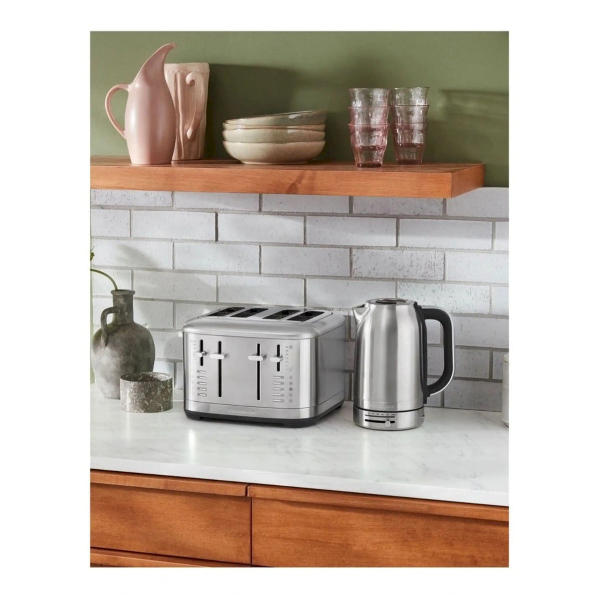 Brushed stainless steel 2-slice toaster on countertop, with two bread slots and controls