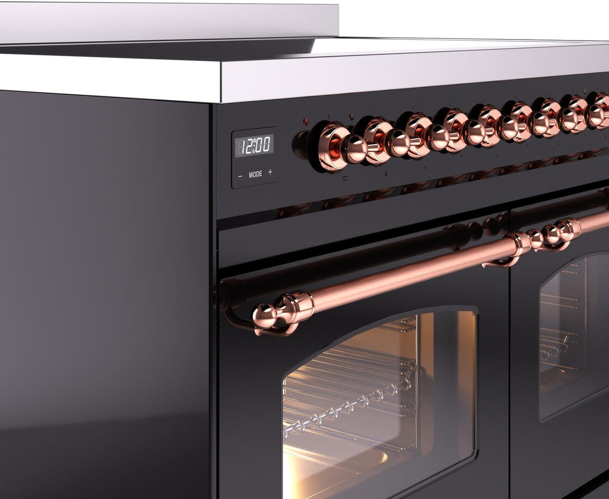 Glossy black induction range control panel with copper knobs and oven handle trim.