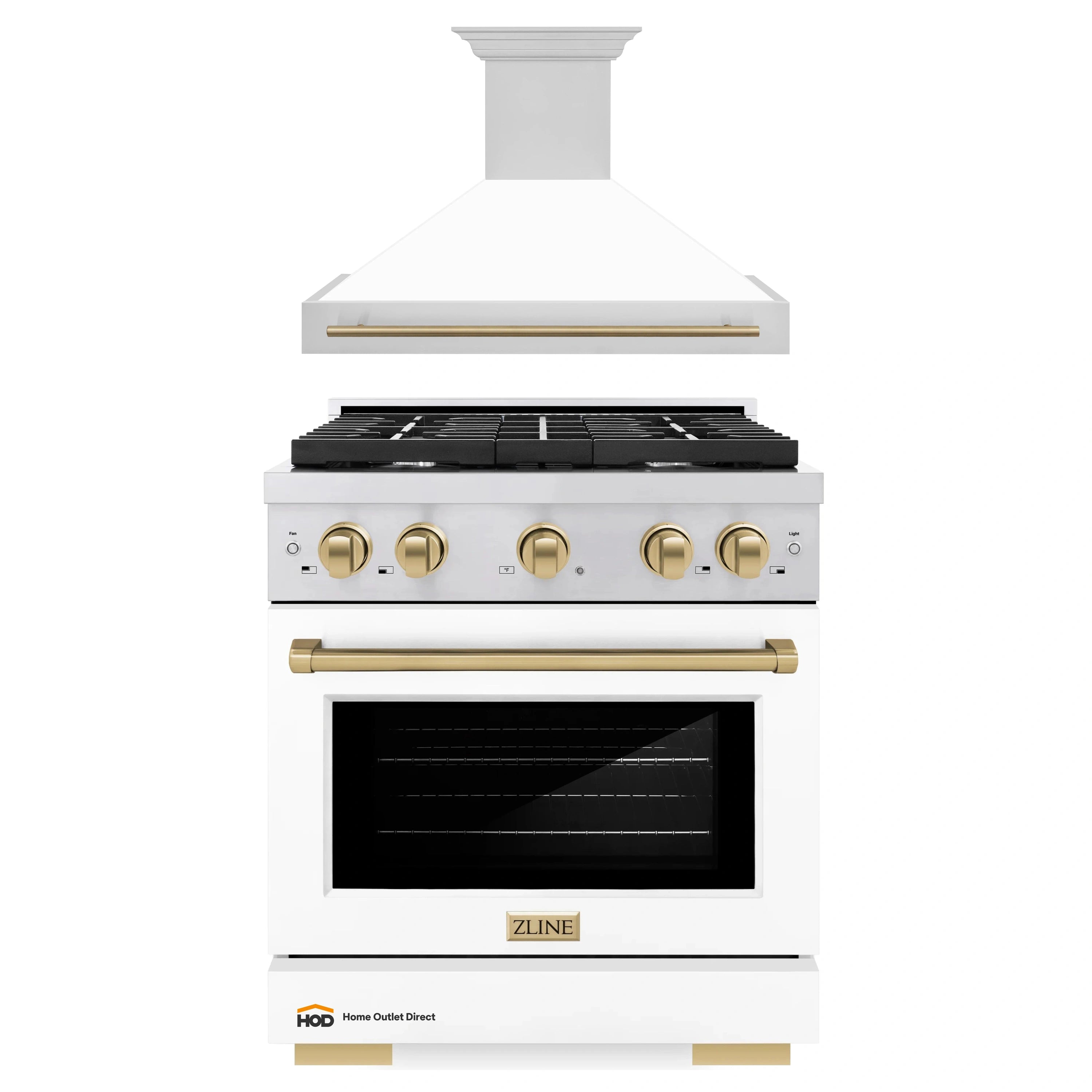 White wall hood over gas range with black grates and champagne bronze control knobs