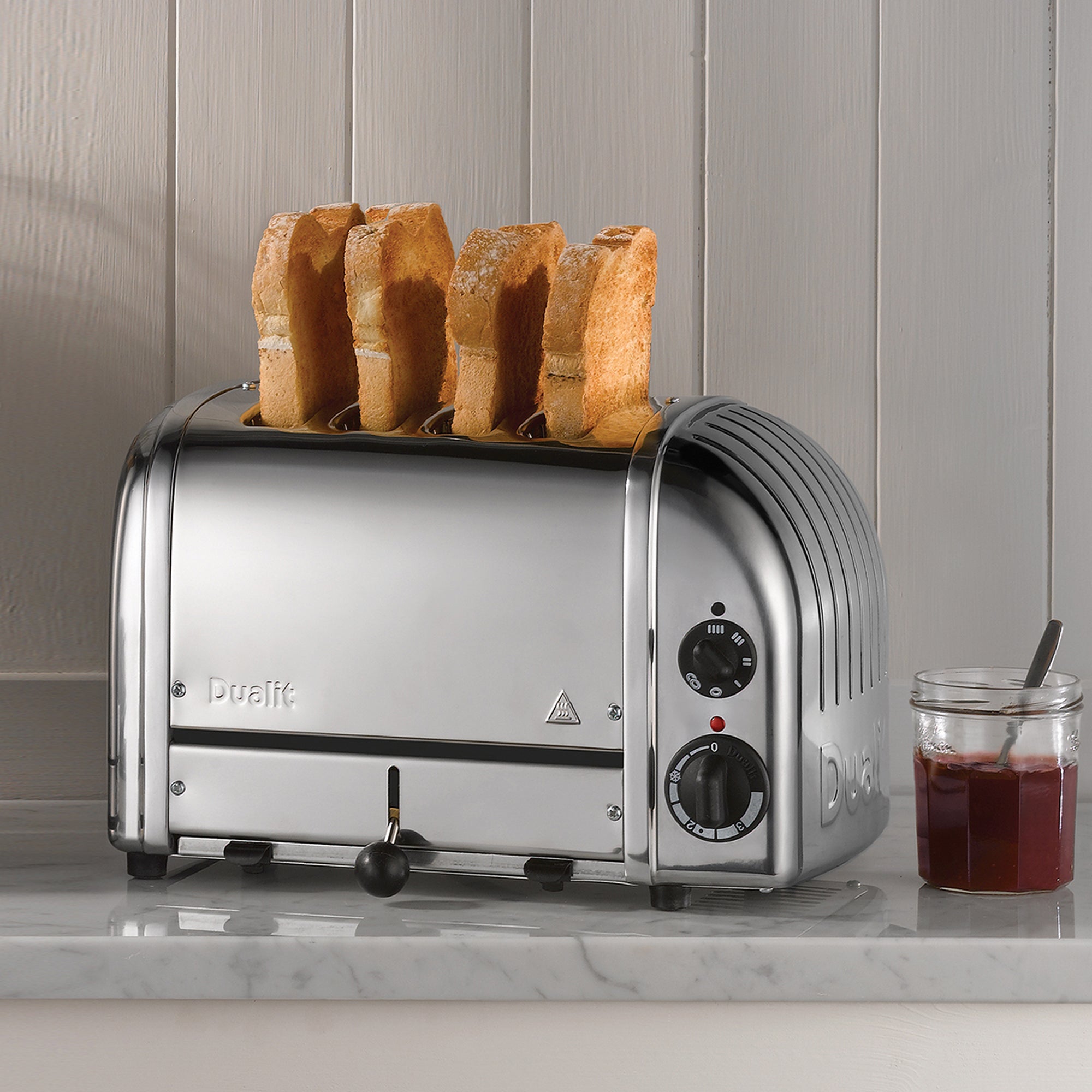 Dualit 4-slice chrome toaster showing upright bread in the slots