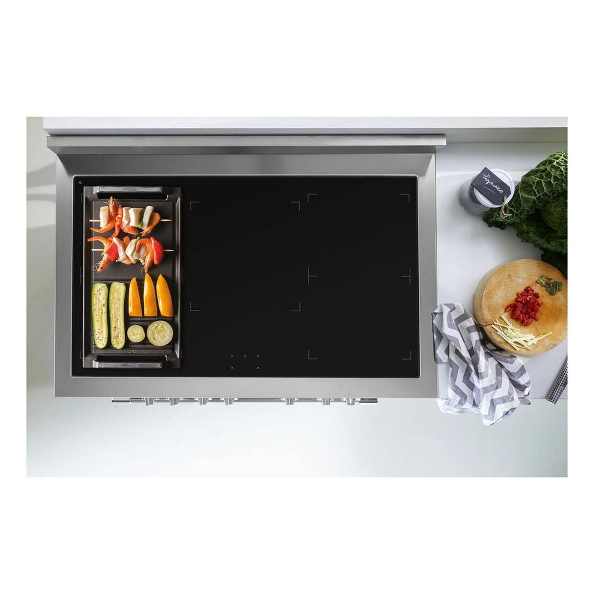 Cast iron induction grill griddle with black cooking surface in a raised tray