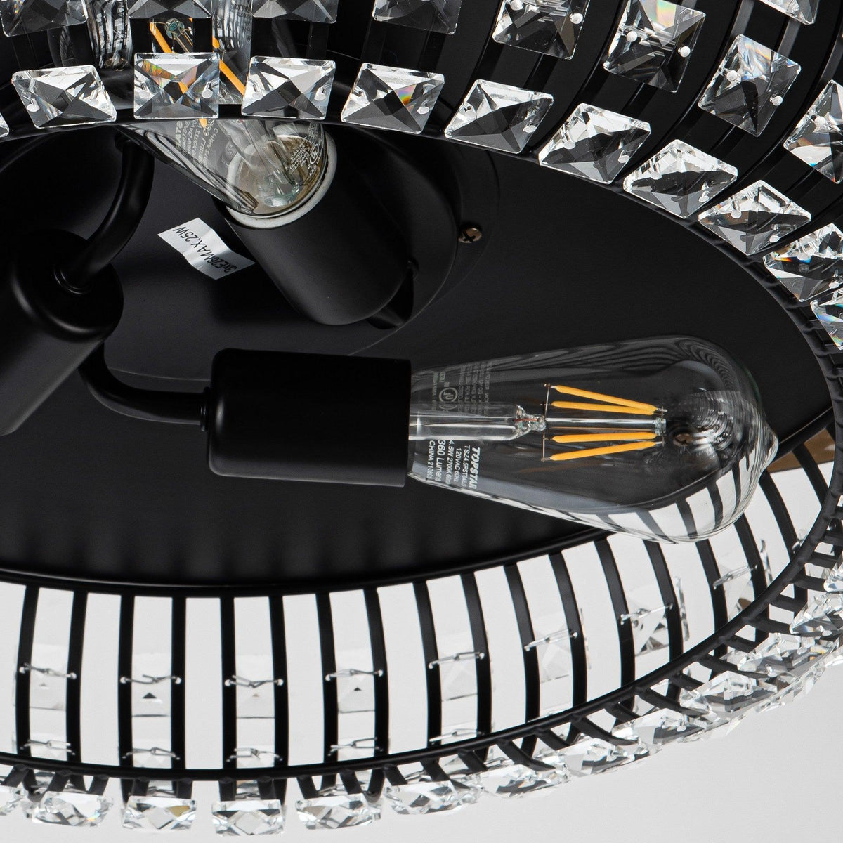 Close-up of black crystal ceiling fan glass pieces and visible light bulb